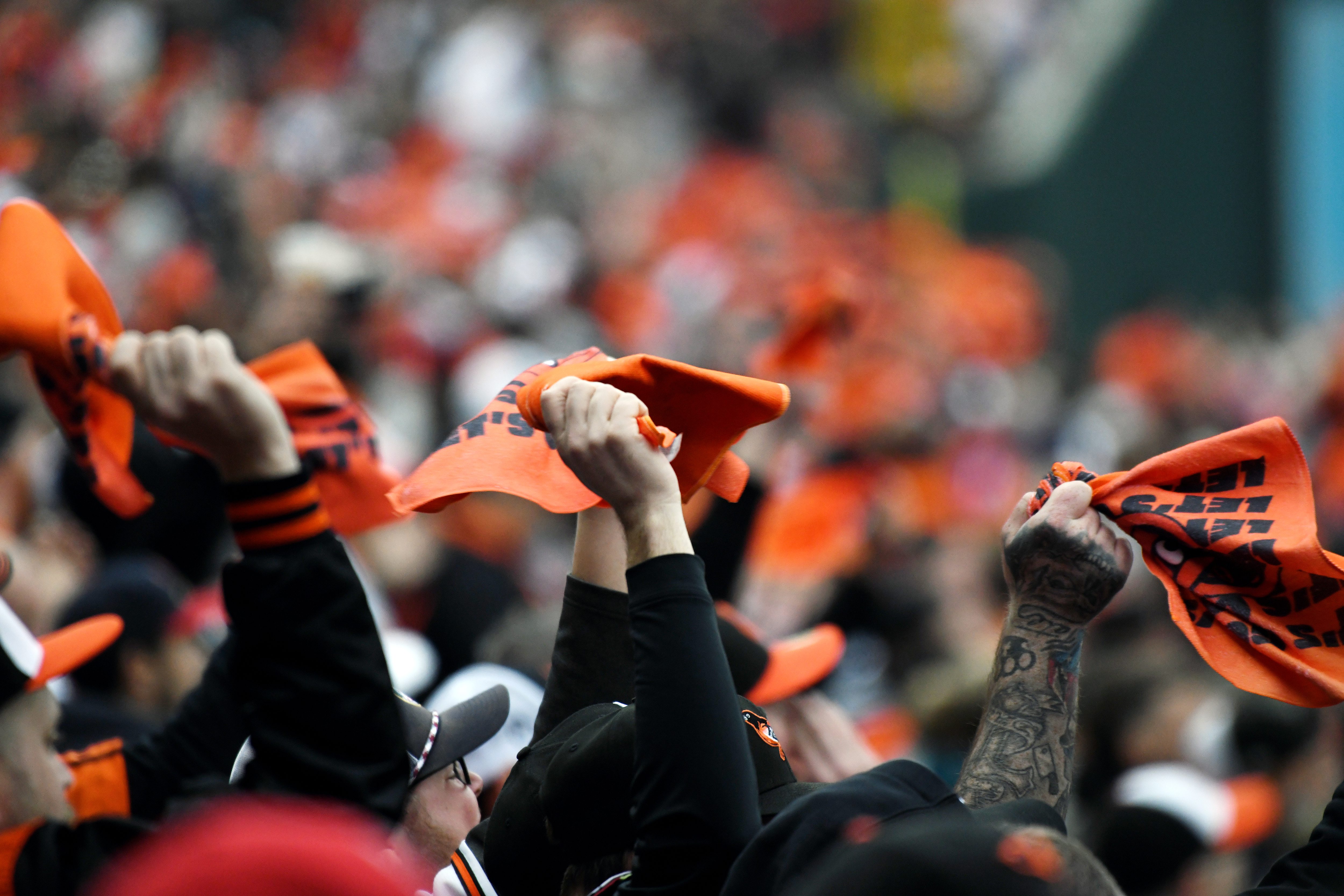 Mar. 28, 2024: Baltimore Orioles fans wave orange towels during the first inning of the opening day game against the Los Angeles Angels at Oriole Park at Camden Yards. (Kim Hairston/Staff)