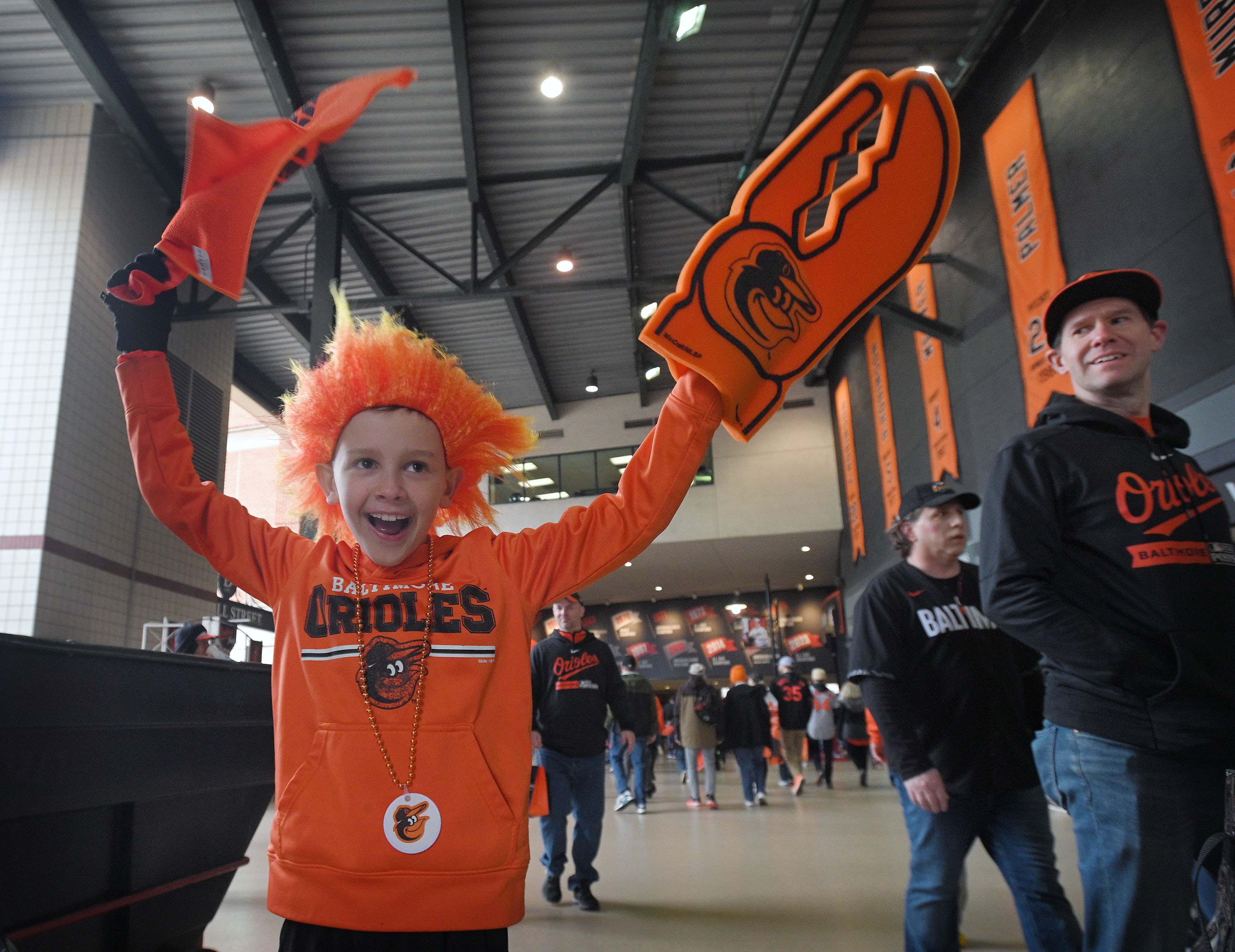 Mar 28, 2024: William Zaron, 10, of Ellicott City, added the orange hair to his opening day outfit for Orioles 2024 season opener at Oriole Park at Camden Yards. (Kenneth K. Lam/Staff)