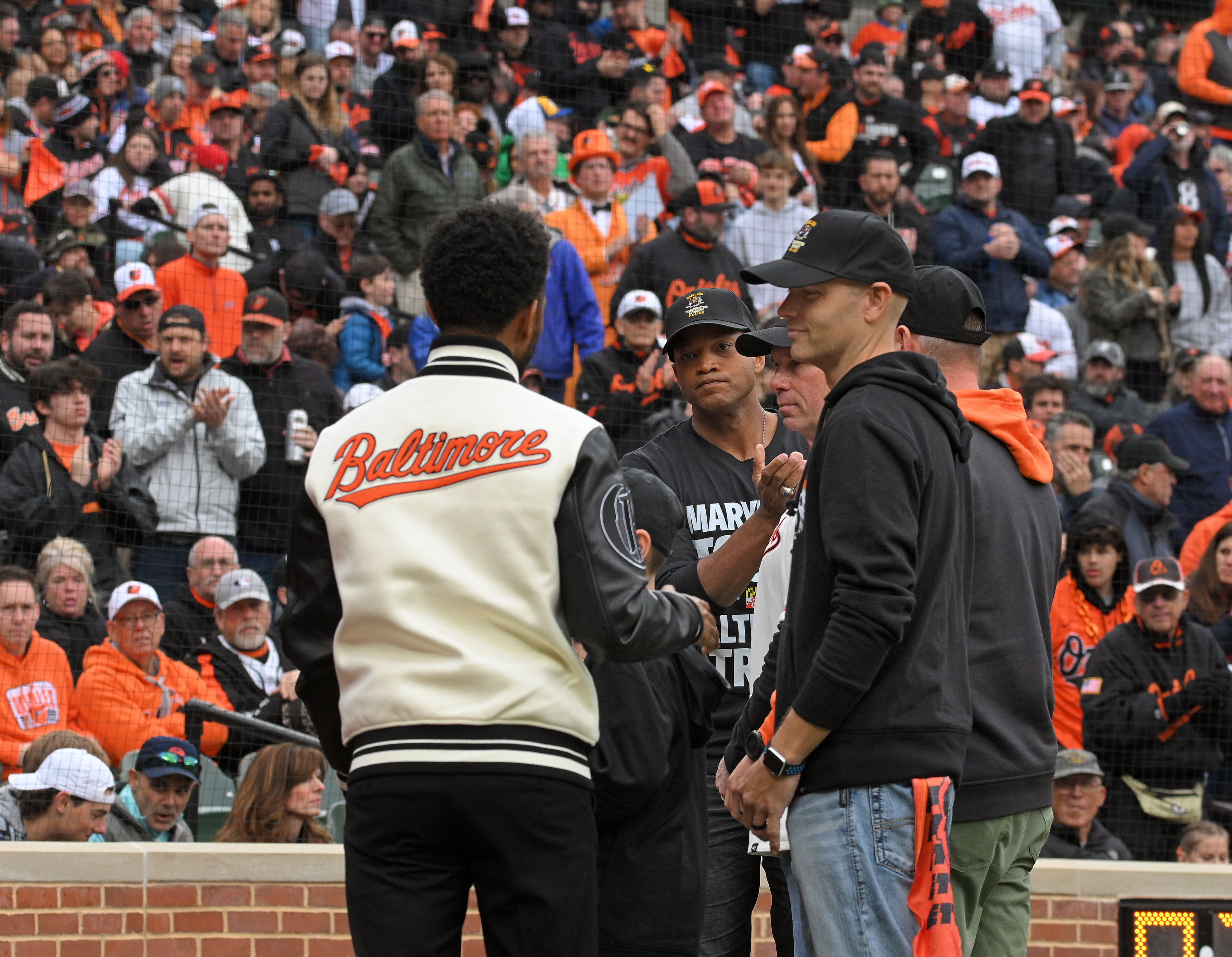 Mar 28, 2024: Baltimore Mayor Brandon Scott, left, and Gov. Wes Moore, center, recognize MTA police officers whose response to the Key Bridge incident helped saved lives during Orioles 2024 season opening day at Oriole Park at Camden Yards. (Kenneth K. Lam/Staff)