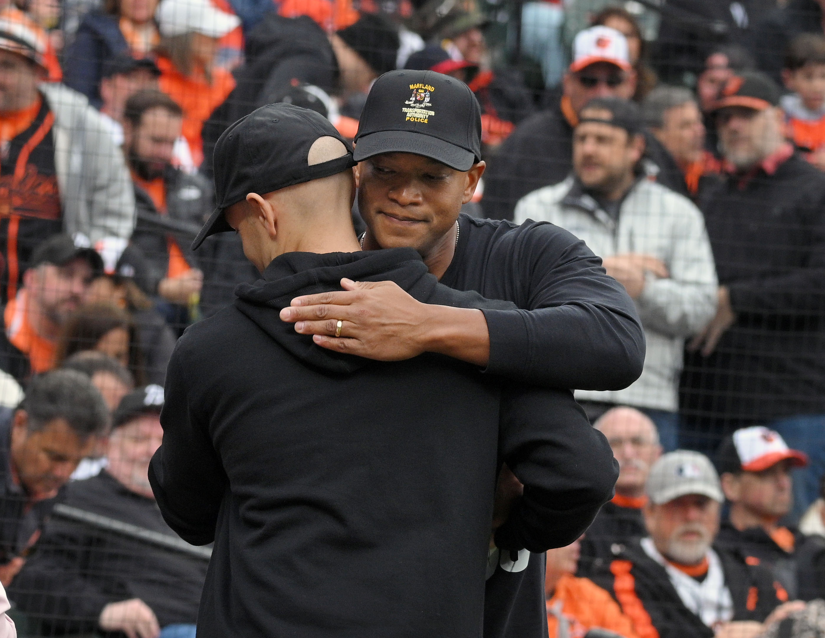 Mar 28, 2024: Gov. Wes Moore hugs one of the MTA police officers who were recognized for their response to the Key Bridge incident that saved lives during Orioles 2024 season opening day at Oriole Park at Camden Yards. (Kenneth K. Lam/Staff)