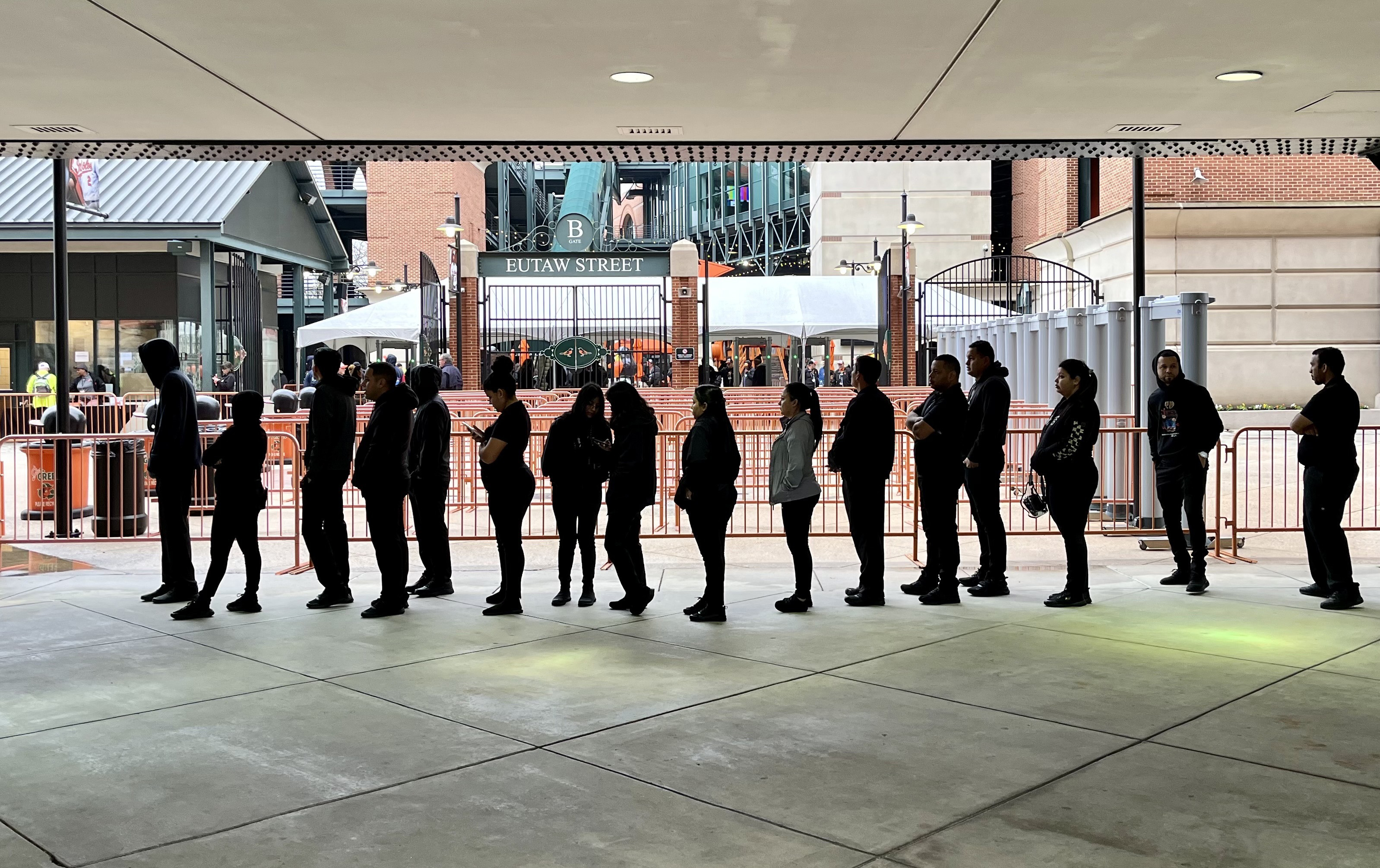 March 28, 2024: Temporary stadium workers line up Thursday morning to check in for opening day at Camden Yards. (Amy Davis)