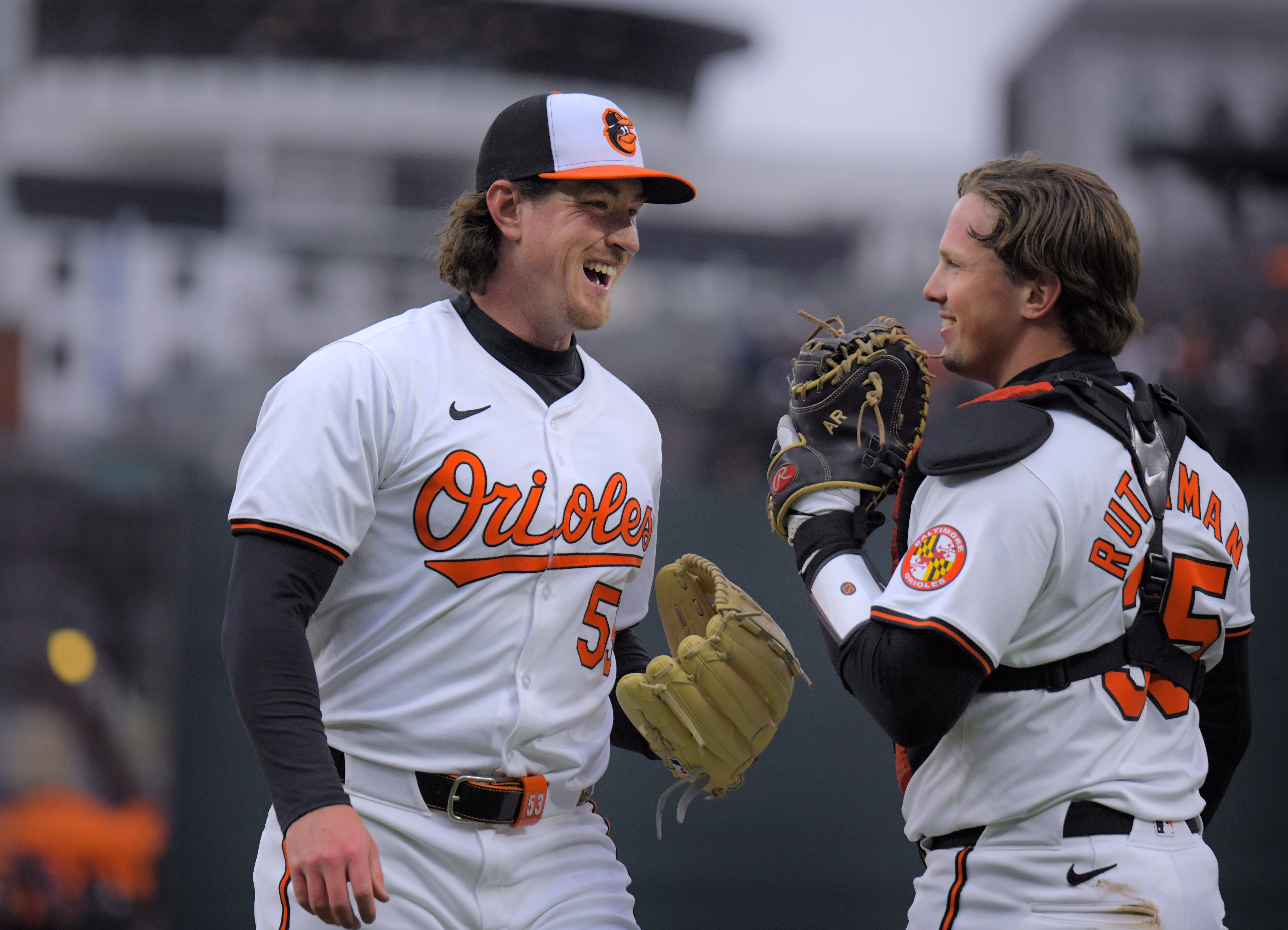 Mar 28, 2024: Baltimore Orioles relief pitcher Mike Baumann smiles with catcher Adley Rutschman after shutting down the Los Angeles Angels during opening day of Major League Baseball at Oriole Park at Camden Yards. (Karl Merton Ferron/Staff)