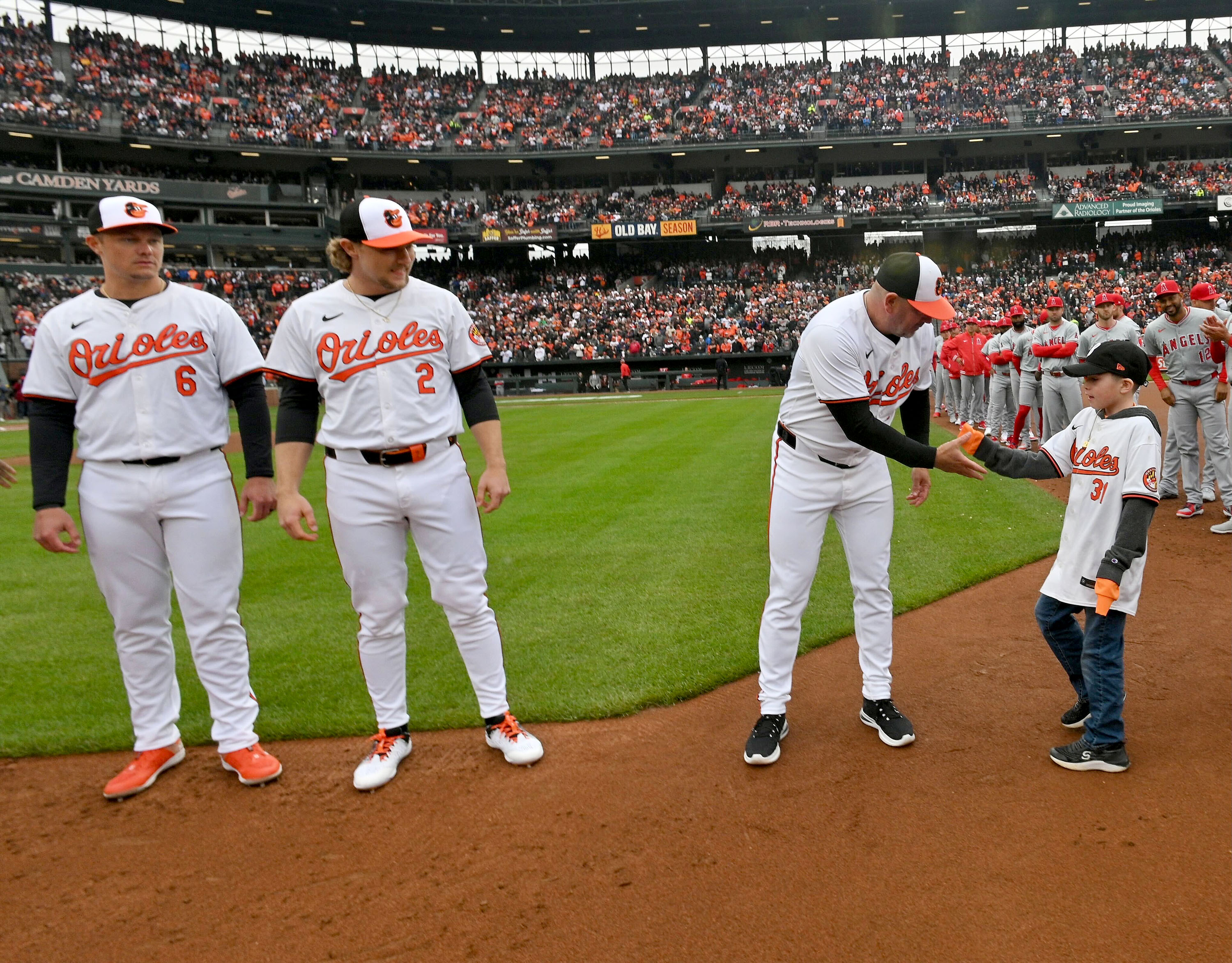 March 28, 2024: Orioles' manager Brandon Hyde greets team's 10th man during the opening day ceremonies at Camden Yards. ( Kenneth K. Lam/Staff)