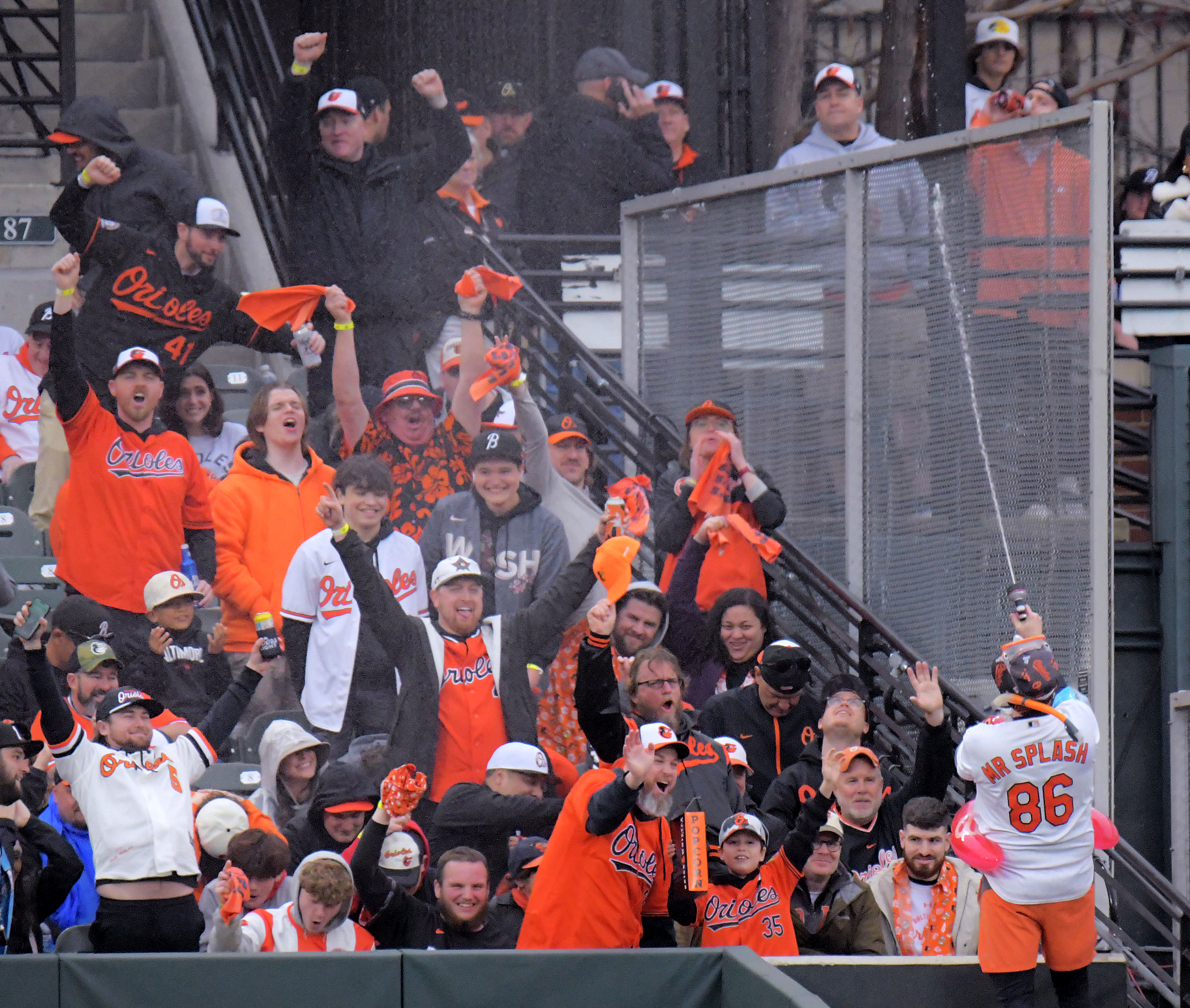 Mar 28, 2024: Baltimore Orioles fans get squirted in celebration of a pinch hit double by Ryan O'Hearn against the Los Angeles Angels during opening day of Major League Baseball at Oriole Park at Camden Yards. (Karl Merton Ferron/Staff)