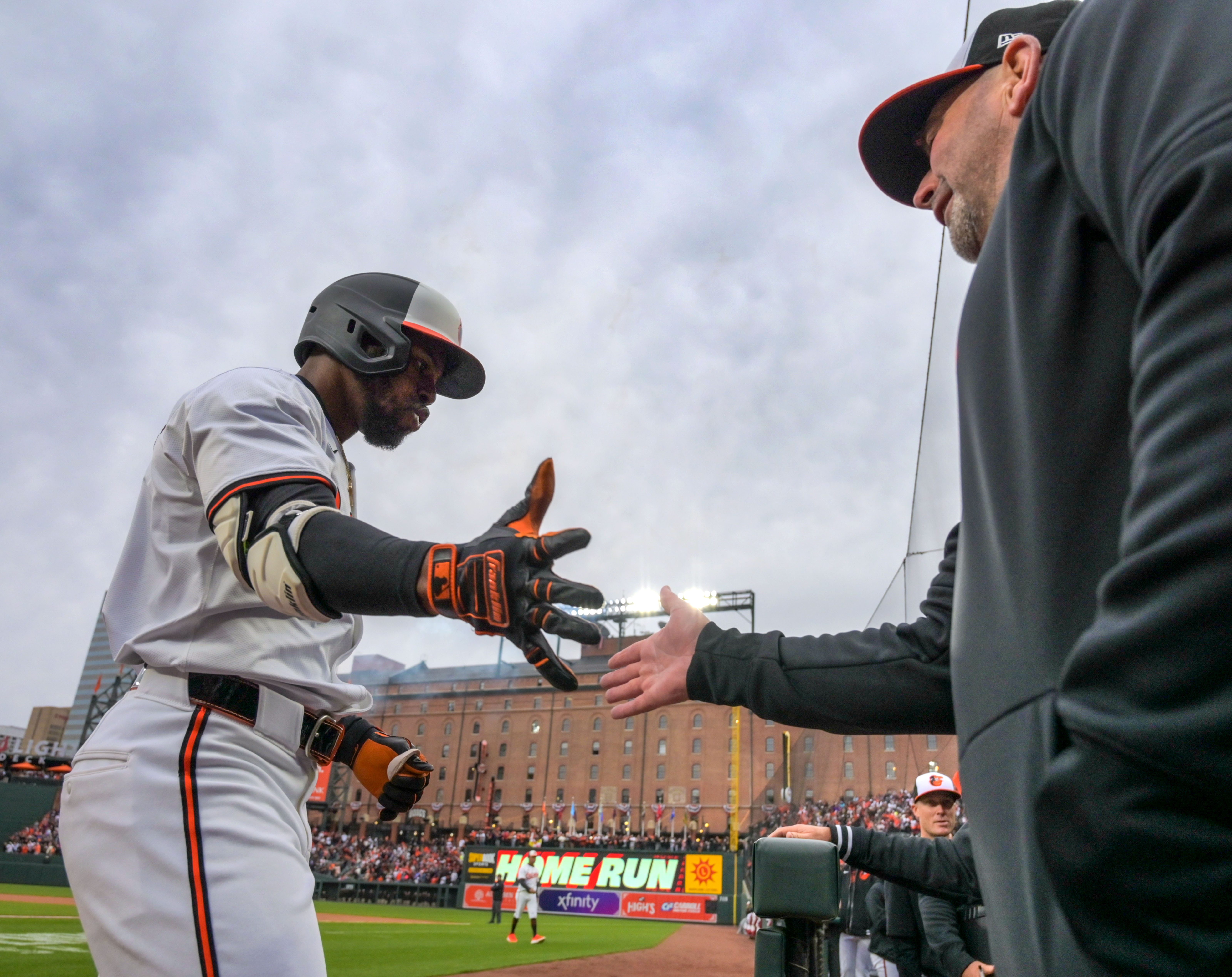 Mar 28, 2024: Baltimore Orioles' Cedric Mullins slaps some skin with manager Brandon Hyde after belting a home run against the Los Angeles Angels during opening day of Major League Baseball at Oriole Park at Camden Yards. (Karl Merton Ferron/Staff)