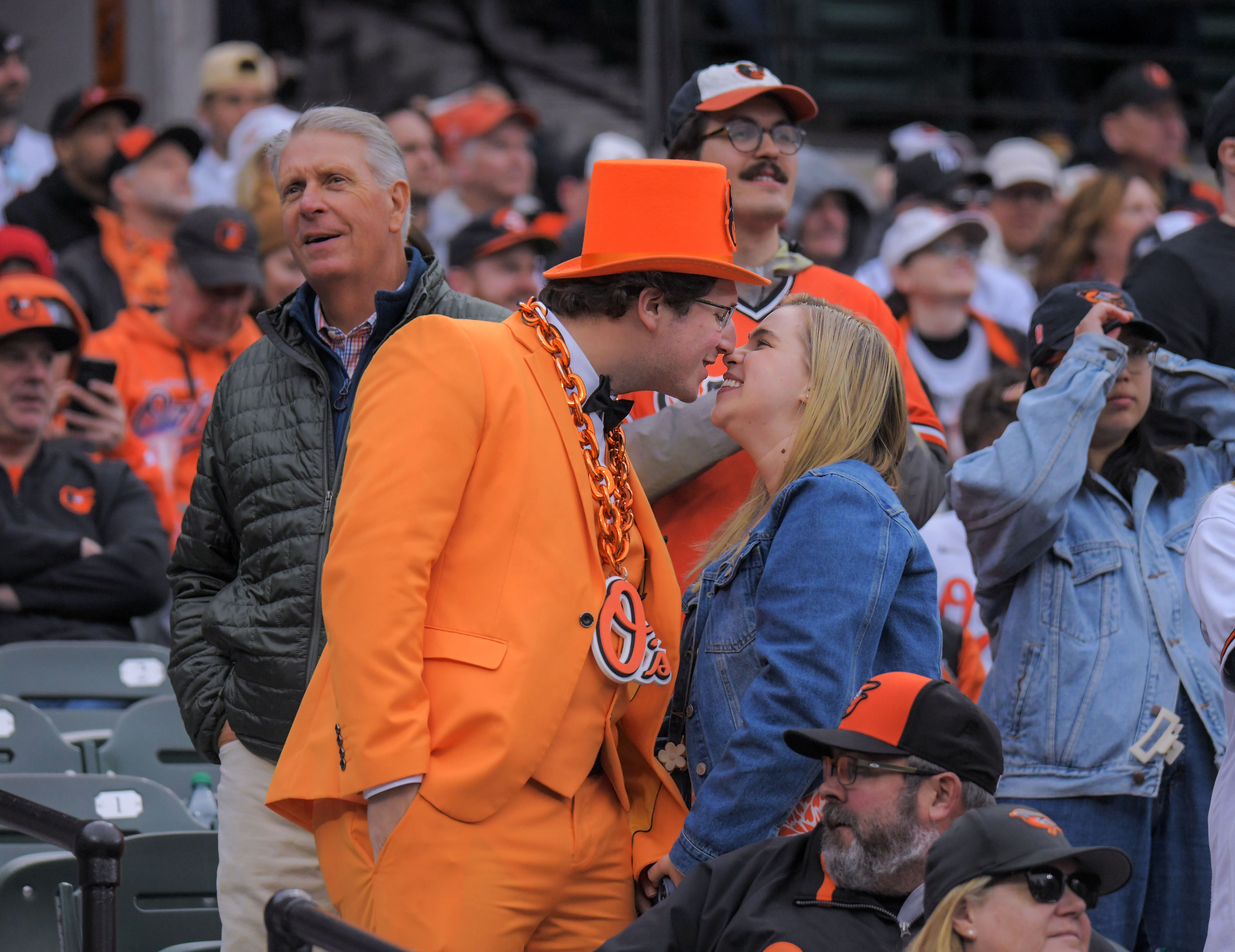 Mar 28, 2024: Freddie Leatherbury of Catonsville and girlfriend Rebecca Kazor of Georgetown enjoy each other during opening day of Major League Baseball at Oriole Park at Camden Yards. (Karl Merton Ferron/Staff)