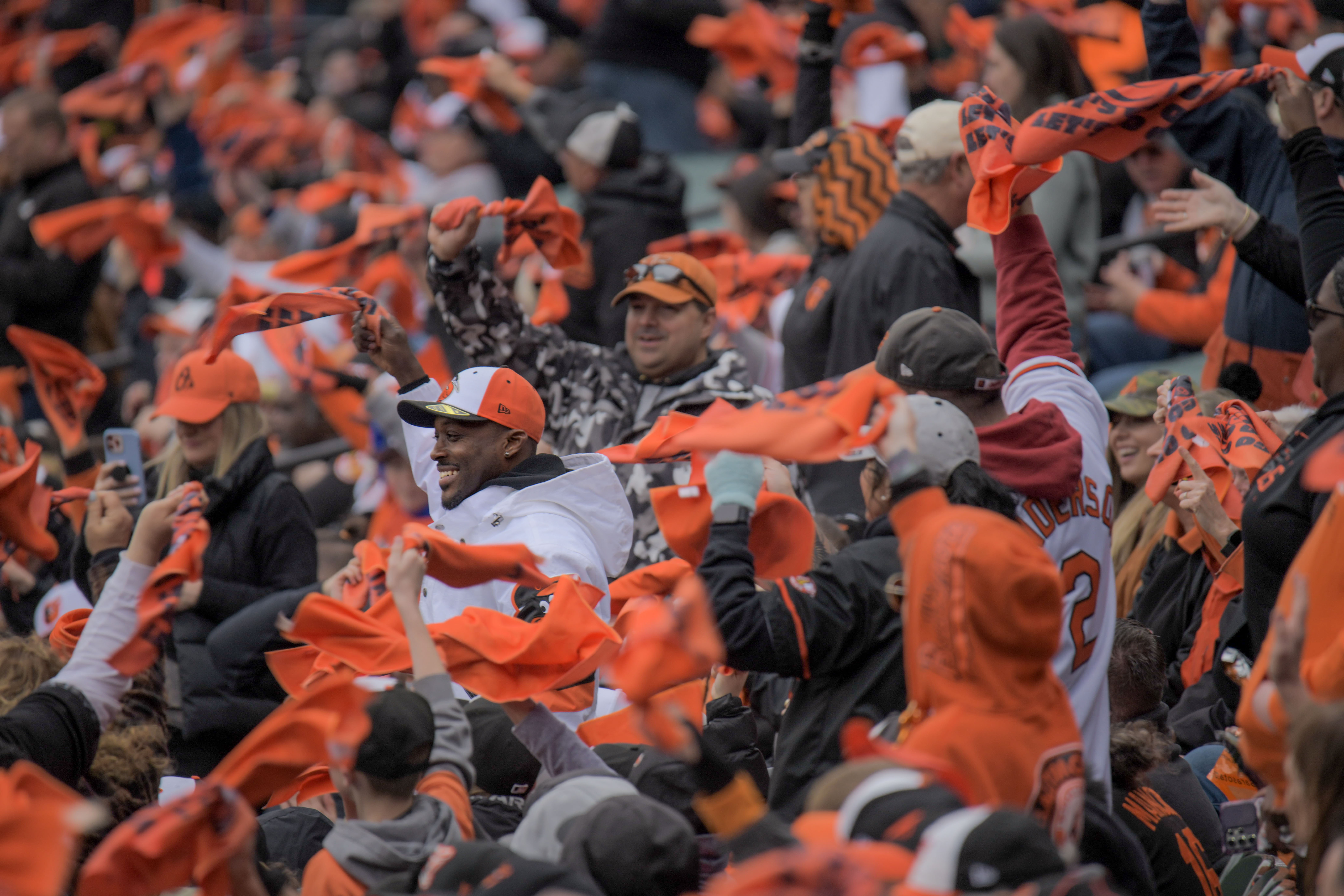 Mar 28, 2024: Fans wave orange towels during a first inning rally against the Los Angeles Angels on opening day of Major League Baseball at Oriole Park at Camden Yards. (Karl Merton Ferron/Staff)