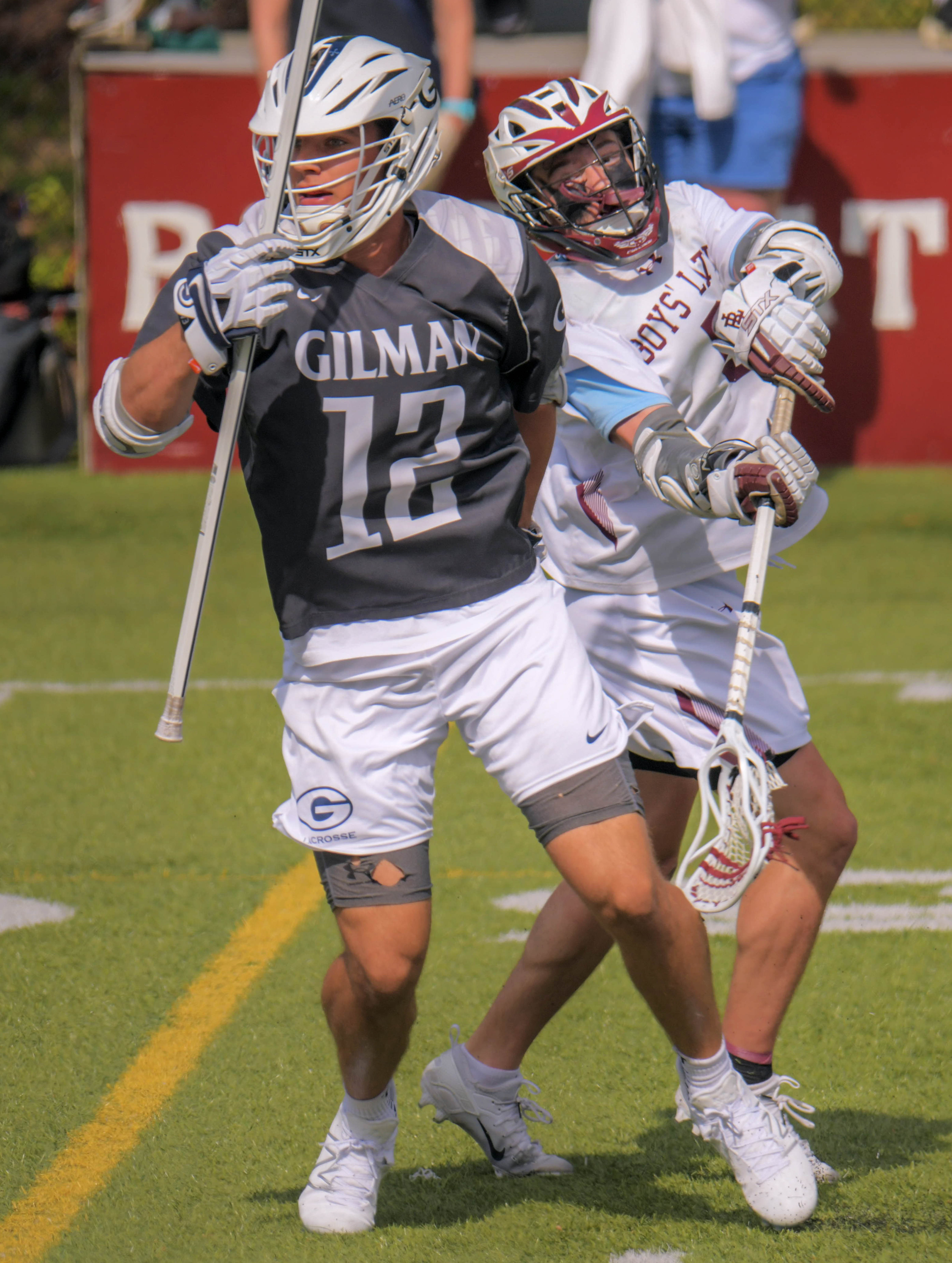 Gilman Greyhounds defenseman George Guyton spins free of Boys' Latin Lakers attackman Matthew Higgins as he brings the ball upfield during MIAA-A boys' lacrosse at Boys' Latin's J. Duncan Smith Field. (Karl Merton Ferron/Staff)