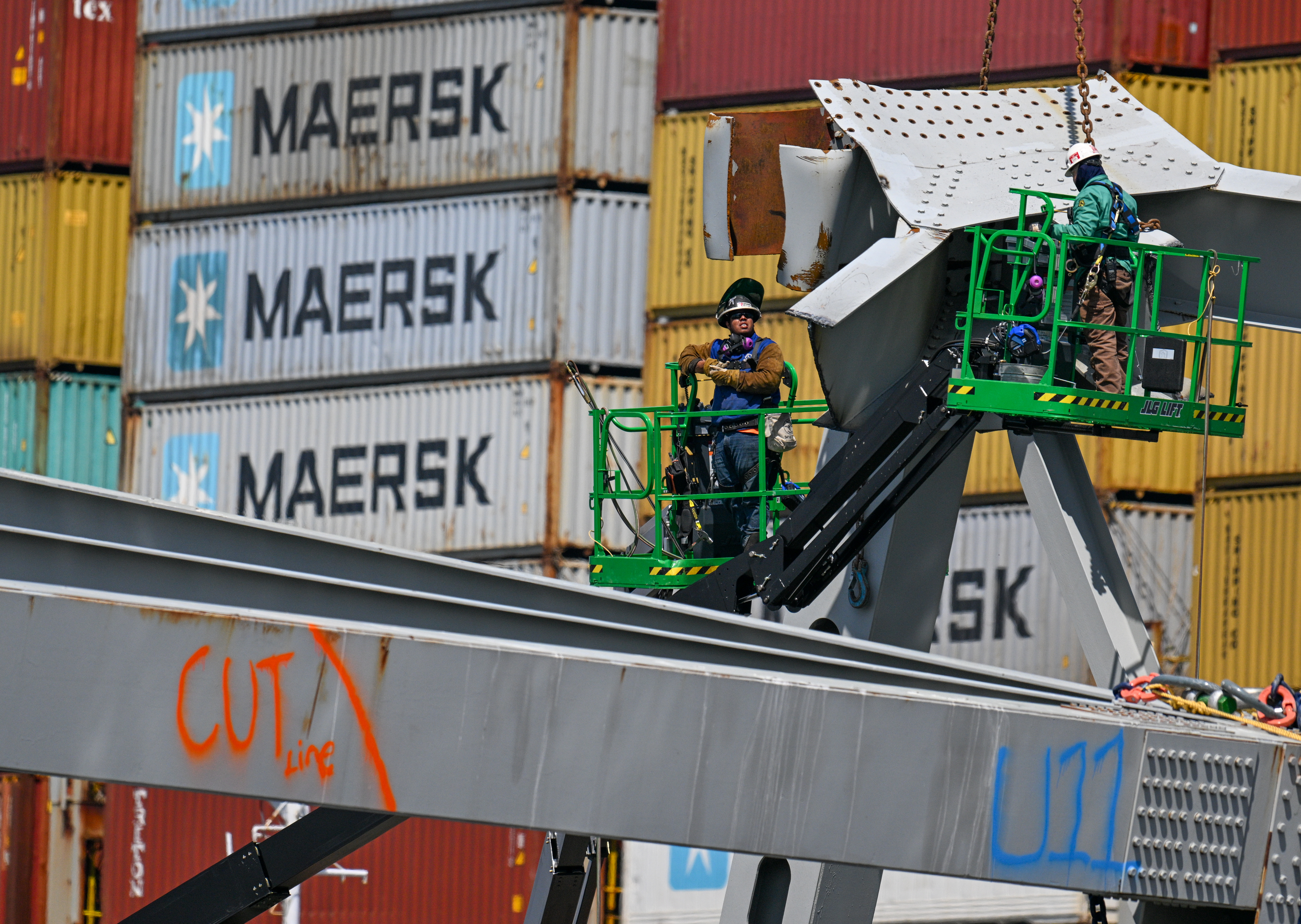 Salvage technicians work on a section of the collapsed Francis Scott Key Bridge.