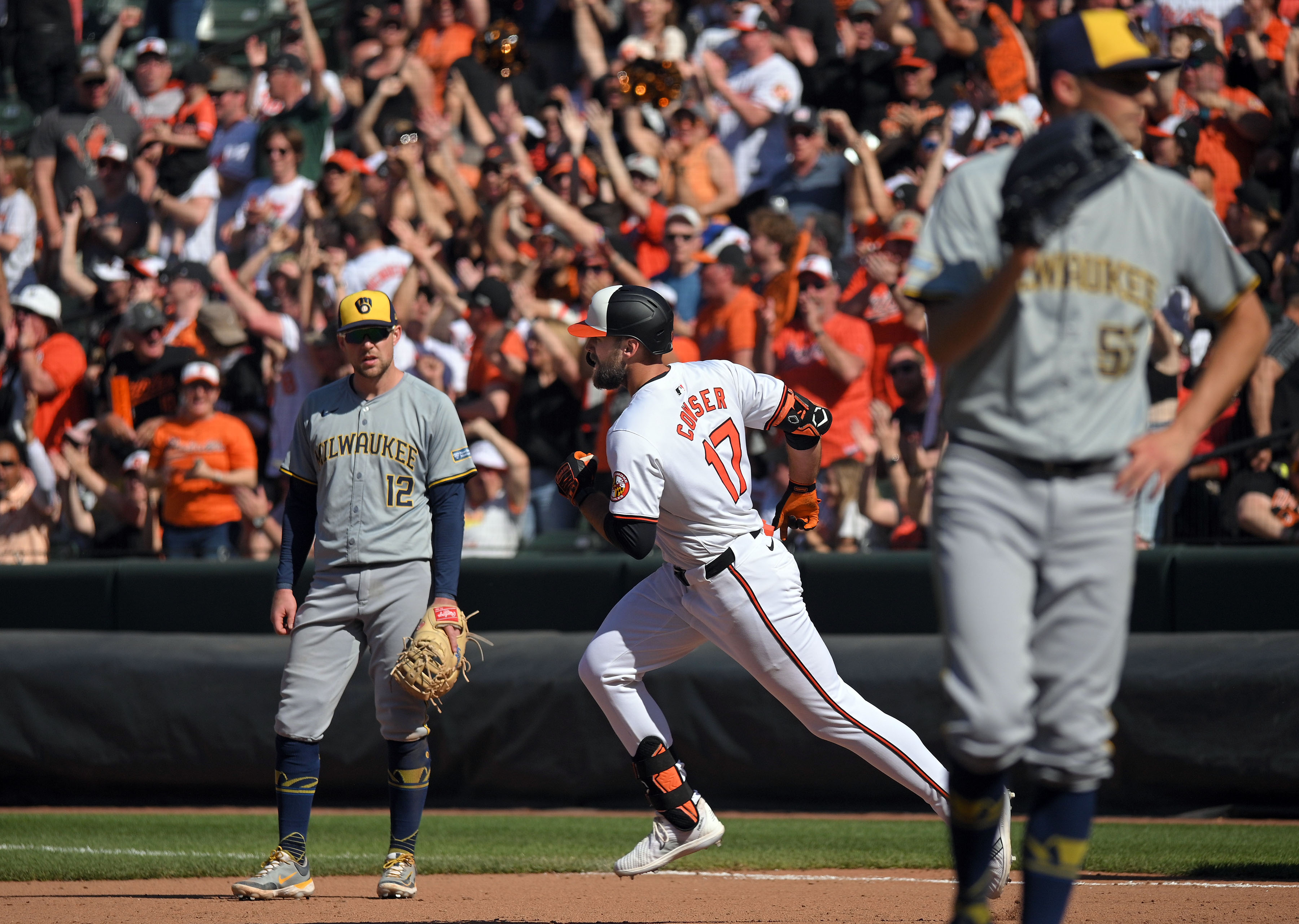 Orioles' Colton Cowser, center, runs past Brewers first baseman Rhys Hoskins, left, after solo homer against pitcher Hoby Milner, right, in the eighth inning. The Orioles defeated the Brewers 6-4 at Oriole Park at Camden Yards. (Kenneth K. Lam/Staff)