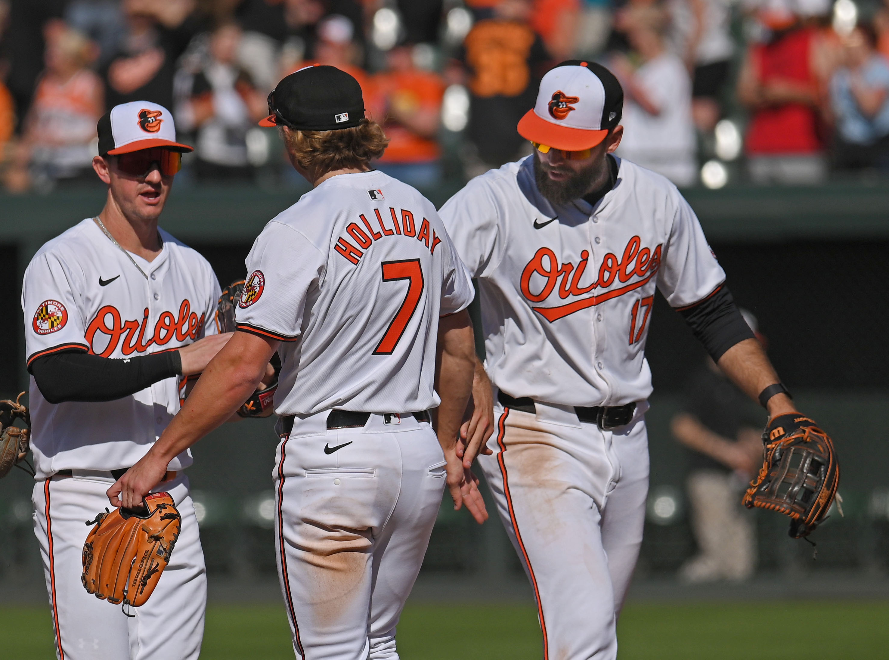 Austin Hays, from left, Jackson Holliday,and Colton Cowser celebrate Orioles' 6-4 victory over the Brewers at Oriole Park at Camden Yards. (Kenneth K. Lam/Staff)