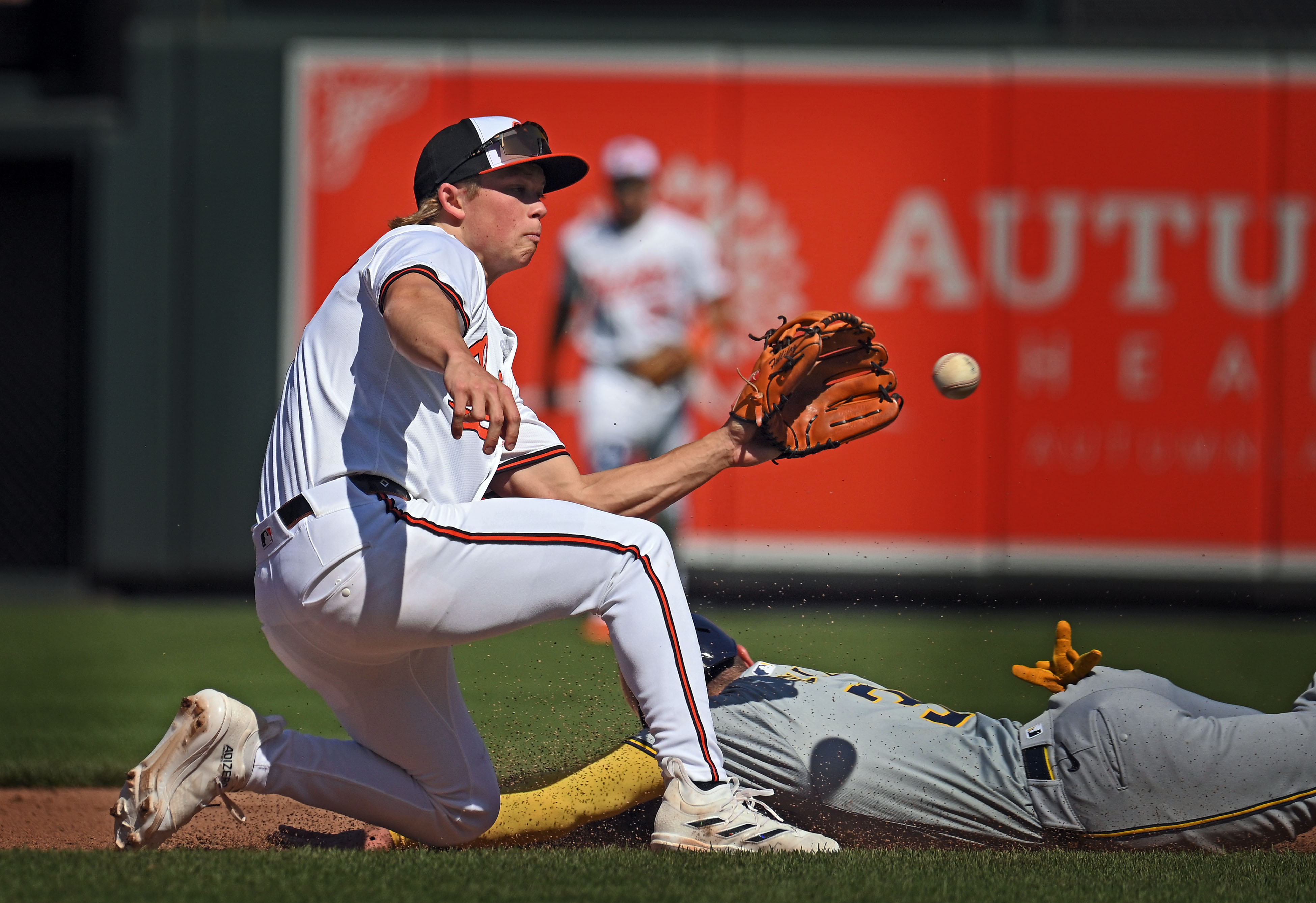 Orioles second baseman Jackson Holliday, left, catches the throw then tags out Brewers' Joey Ortiz on a steal base attempt in the sixth inning. The Orioles defeated the Brewers 6-4 at Oriole Park at Camden Yards. (Kenneth K. Lam/Staff)