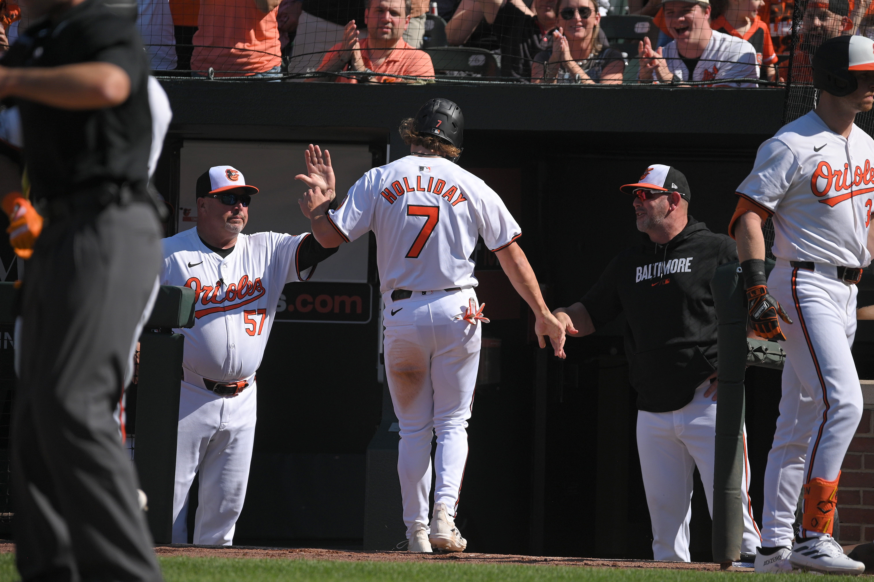 Orioles' Jackson Holliday celebrates as he enters the dugout after scoring in the seventh inning. He had his first MLB hit, a single, during the inning in a game against the Milwaukee Brewers. (Kenneth K. Lam/staff)