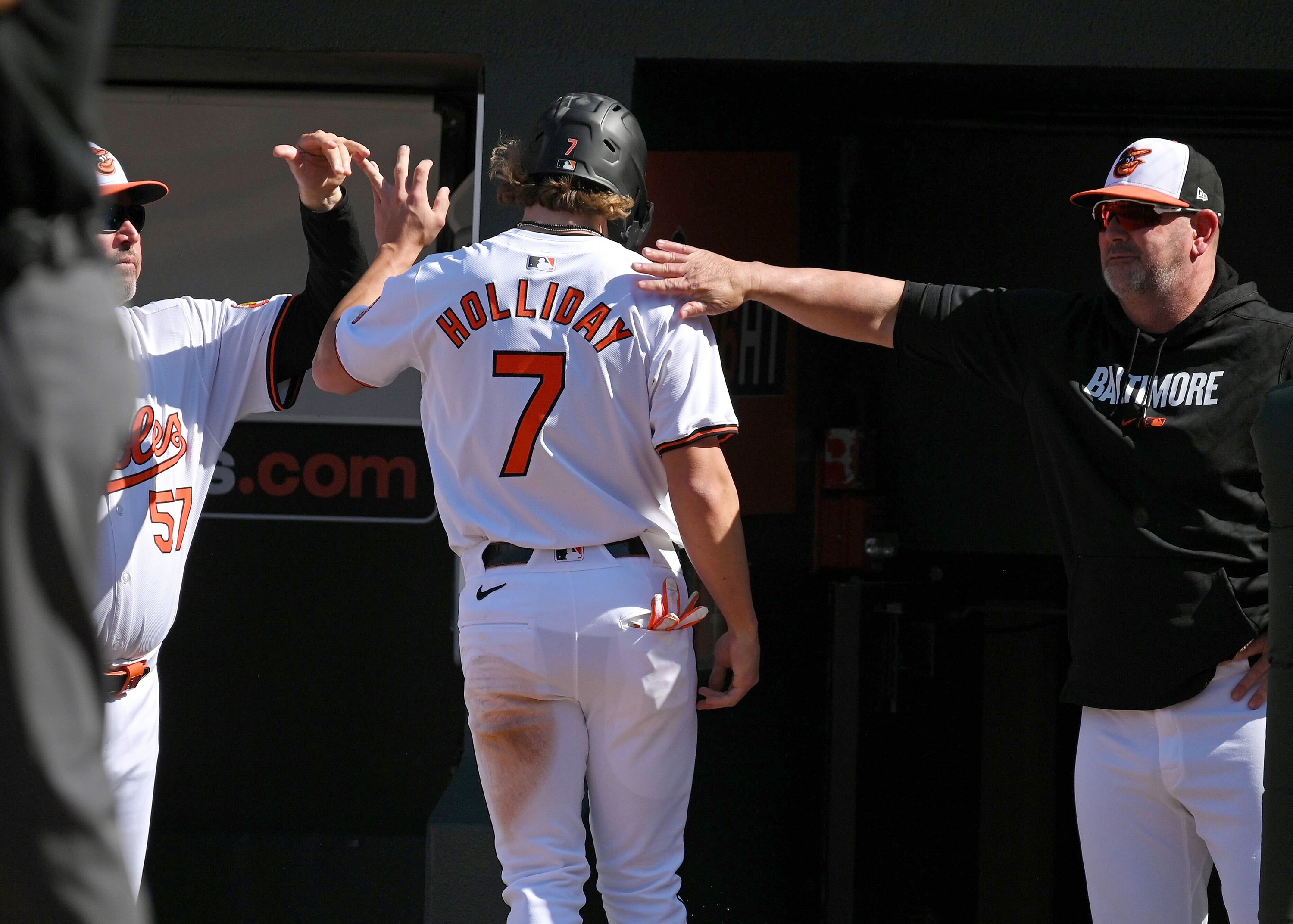 Orioles' Jackson Holliday celebrates as he enters the dugout after scoring in the seventh inning. He had his first MLB hit, a single, during the inning in a game against the Milwaukee Brewers. (Kenneth K. Lam/staff)