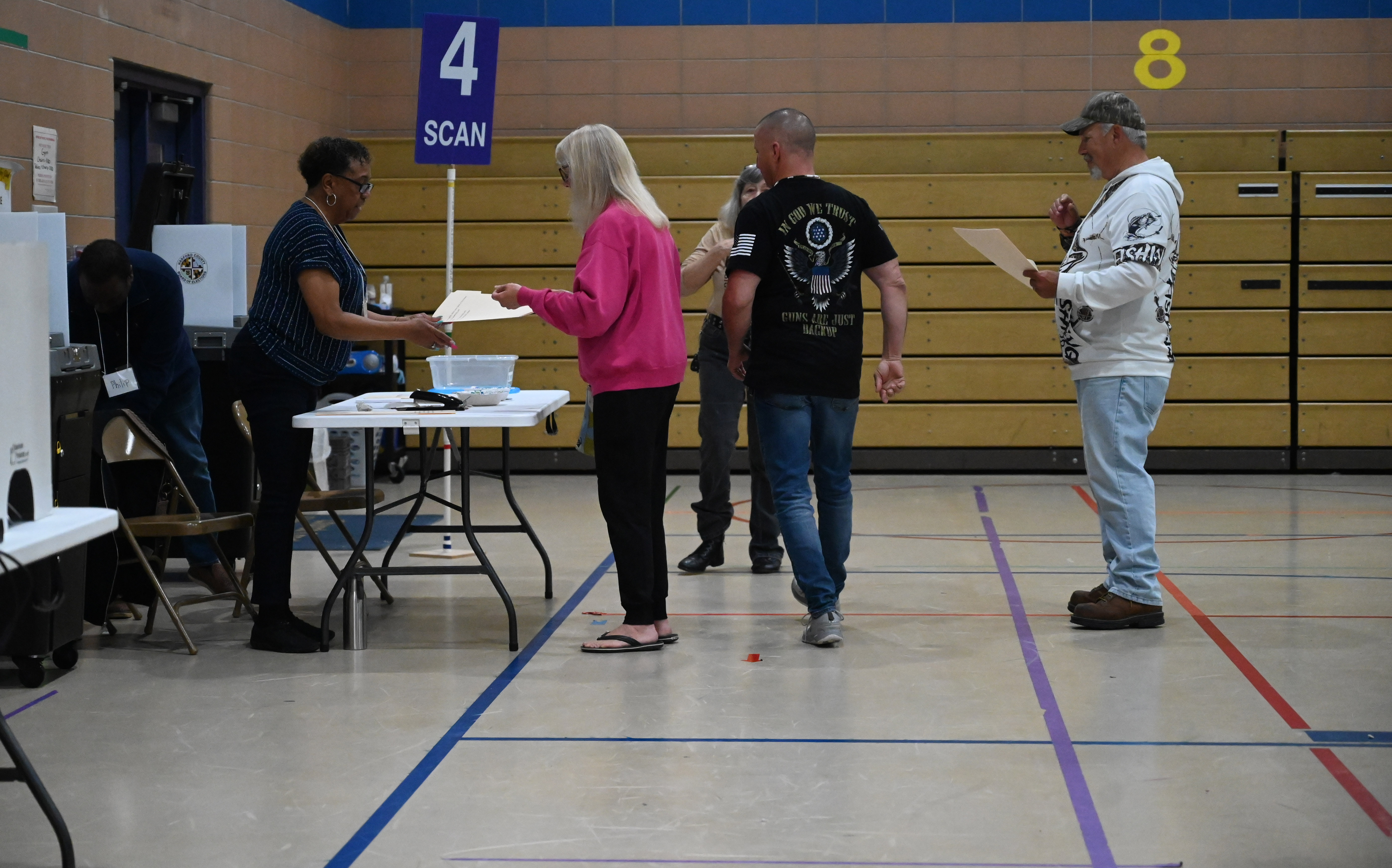 Early morning voters line up to scan their ballot at the polling location at Church Creek Elementary for Maryland's primary election on Tuesday. (Brian Krista/staff photo)