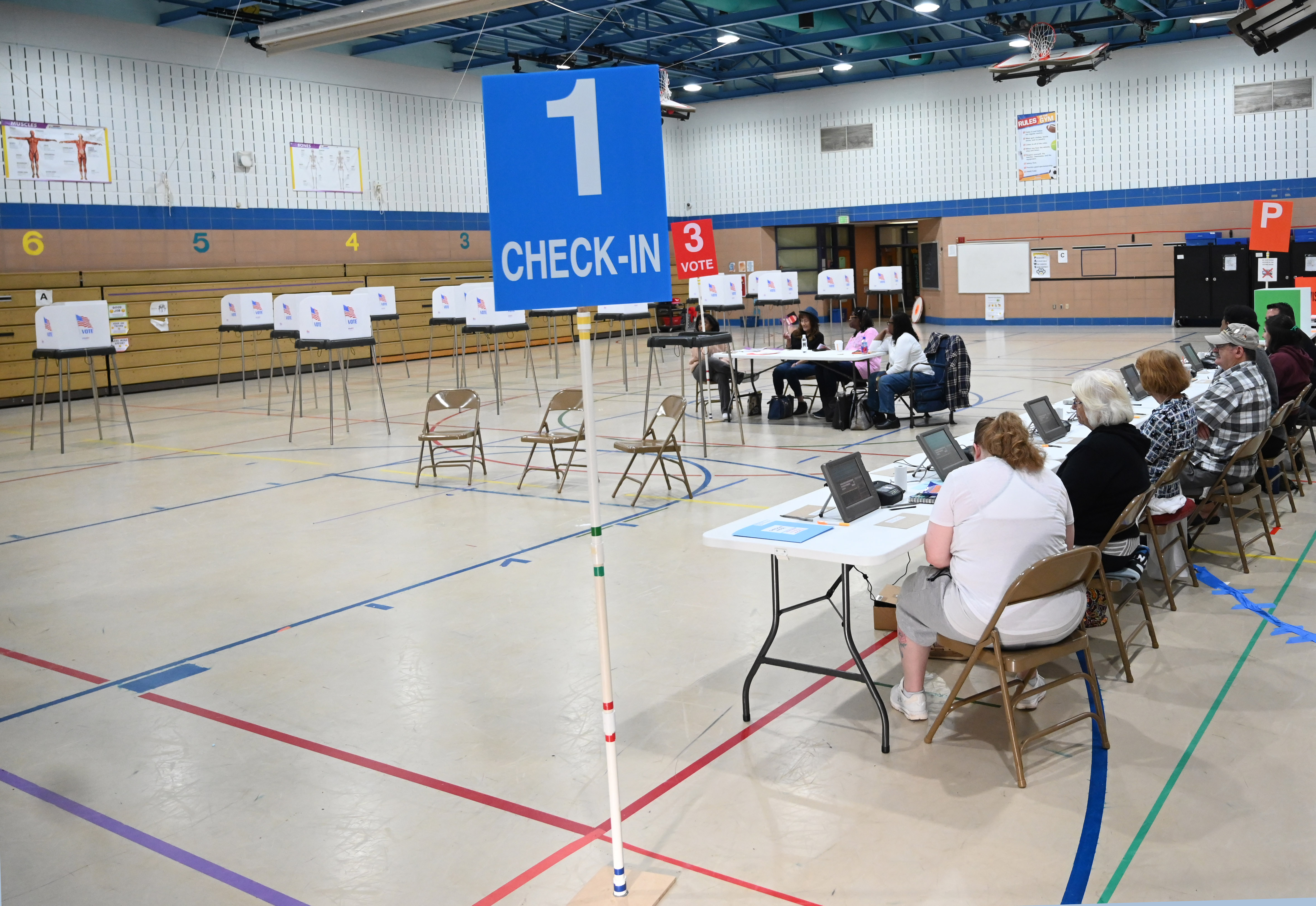 Election officials wait for voters to arrive at the polling location at Church Creek Elementary for Maryland's primary election on Tuesday. (Brian Krista/staff photo)