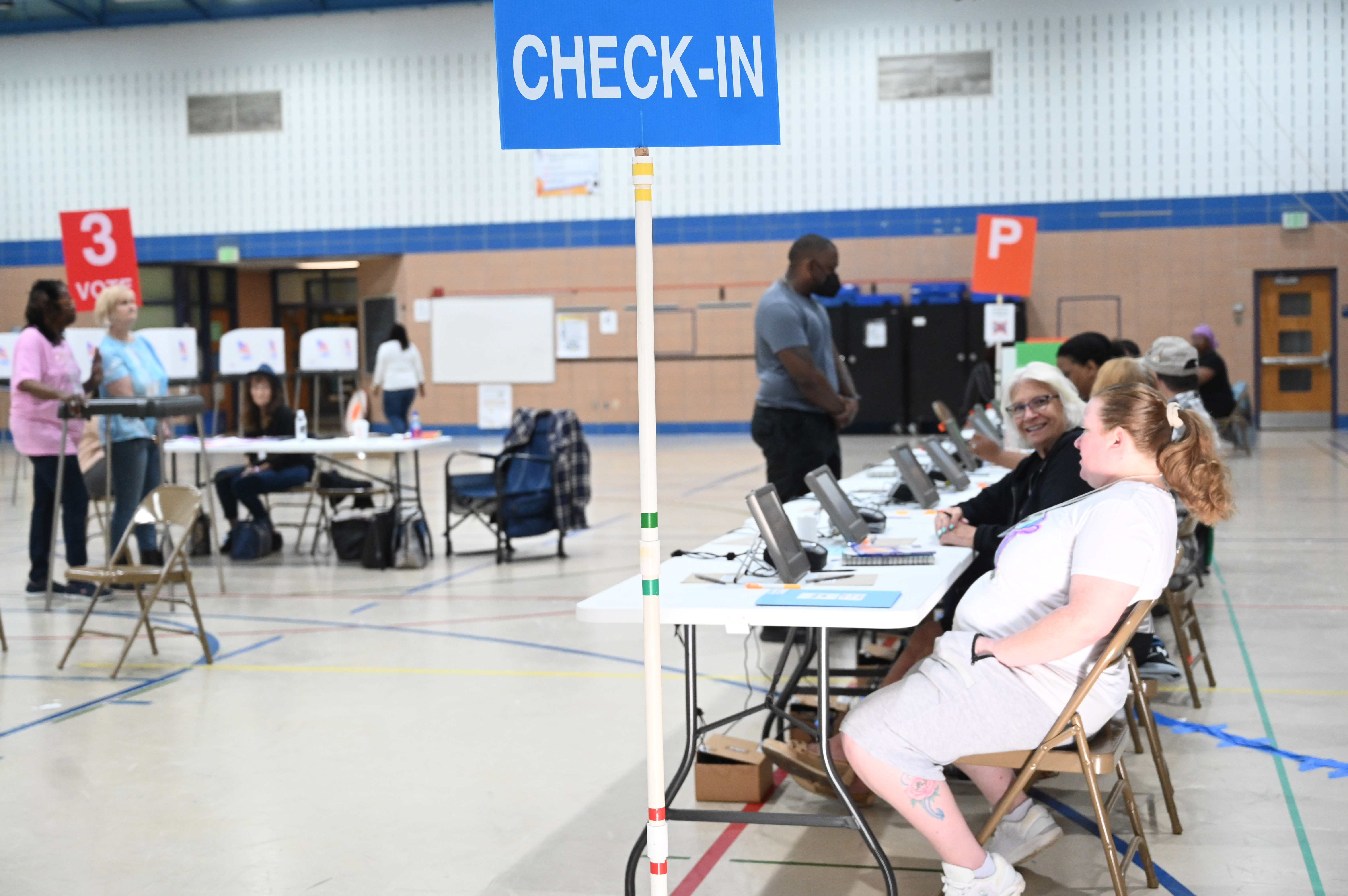 Election officials wait to check-in voters at the polling location at Church Creek Elementary for Maryland's primary election on Tuesday. (Brian Krista/staff photo)