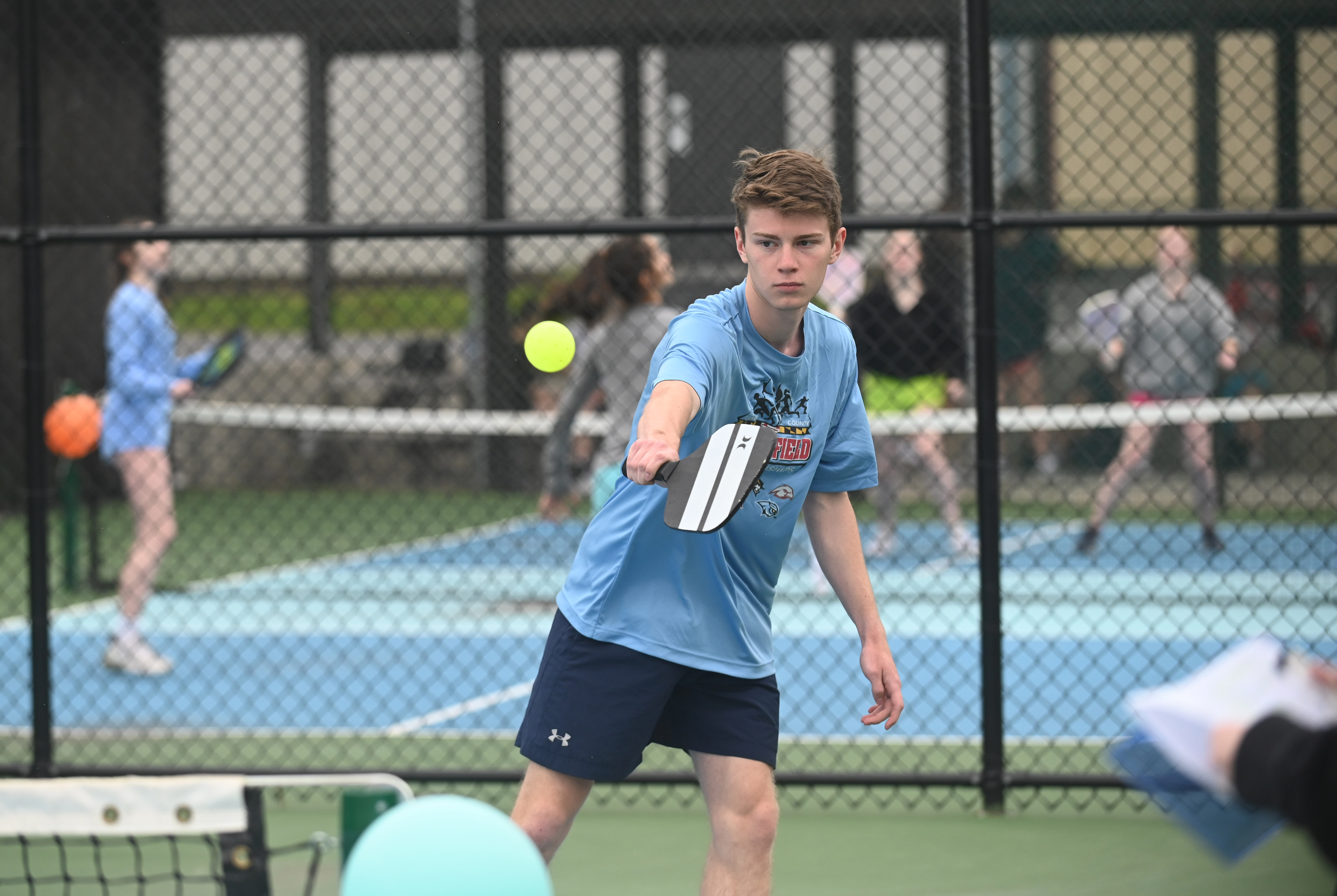 Jace Calhoun makes a play on the ball as he competes in a pickleball tournament at Coppermine 4 Seasons on Tuesday. The tournament was organized by Manchester Valley High School juniors Brady Bonney and Leigh Hoke to raise money and support for Morgan's Message, a non-profit supporting student-athlete mental health initiatives. (Brian Krista/staff photo)