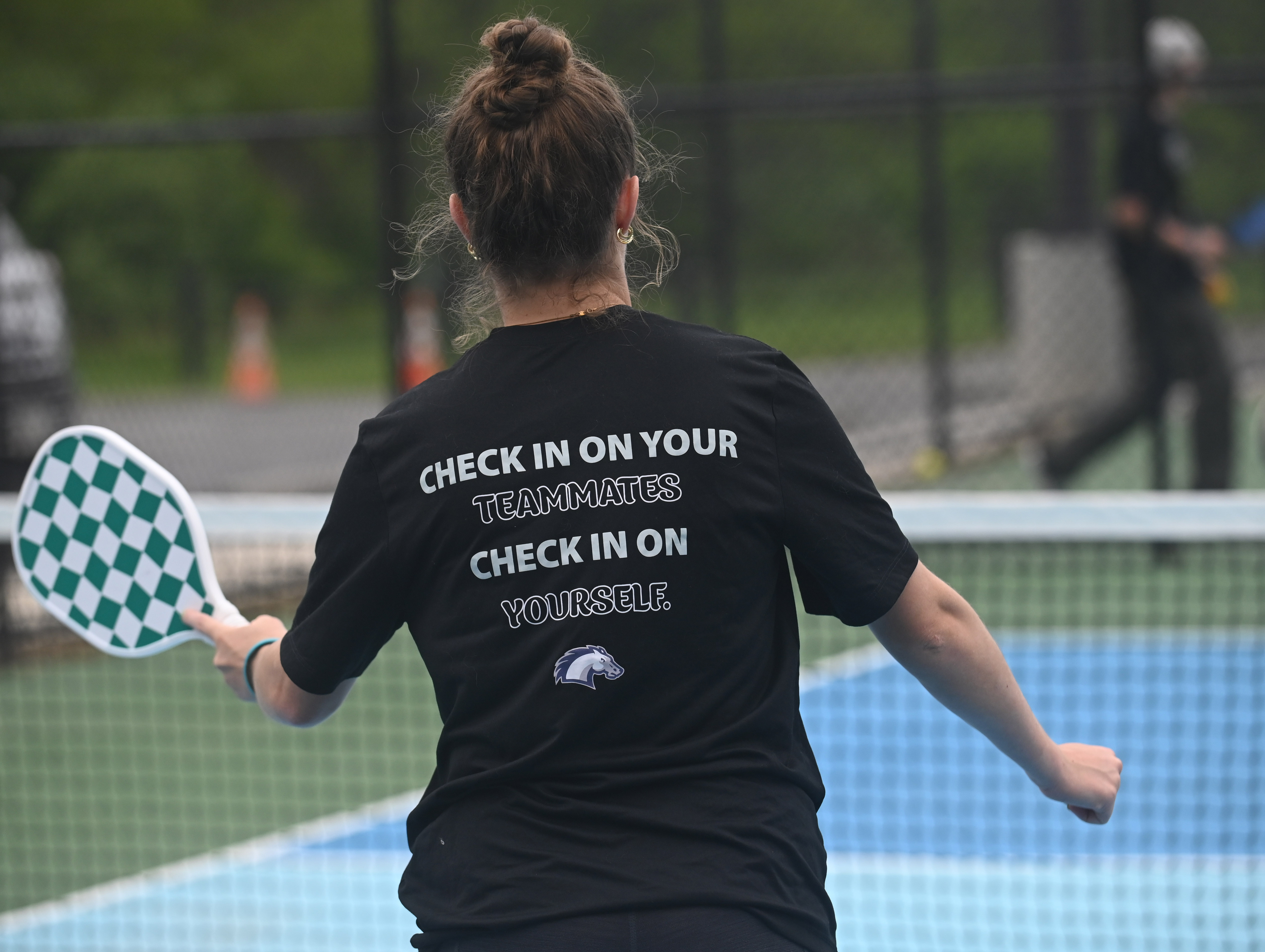 The back of a shirt worn by Emily Fischer is seen as she competes in a pickleball tournament at Coppermine 4 Seasons on Tuesday. The tournament was organized by Manchester Valley High School juniors Brady Bonney and Leigh Hoke to raise money and support for Morgan's Message, a non-profit supporting student-athlete mental health initiatives. (Brian Krista/staff photo)