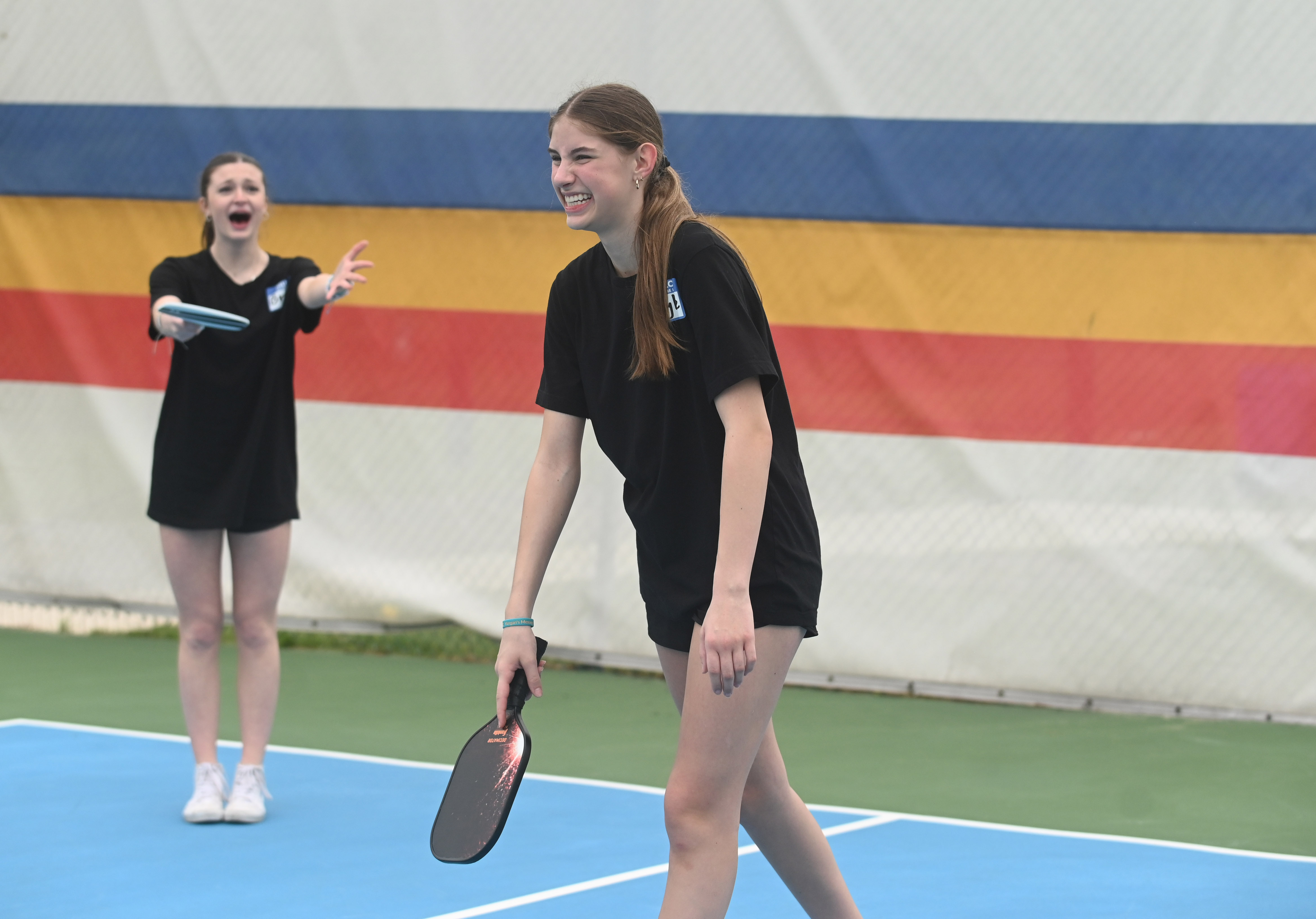 Freshmen Ryann Hoke, left, and Brenna Maas react after a missed shot during a pickleball tournament at Coppermine 4 Seasons on Tuesday. The tournament was organized by Manchester Valley High School juniors Brady Bonney and Leigh Hoke to raise money and support for Morgan's Message, a nonprofit supporting student-athlete mental health initiatives. (Brian Krista/staff photo)