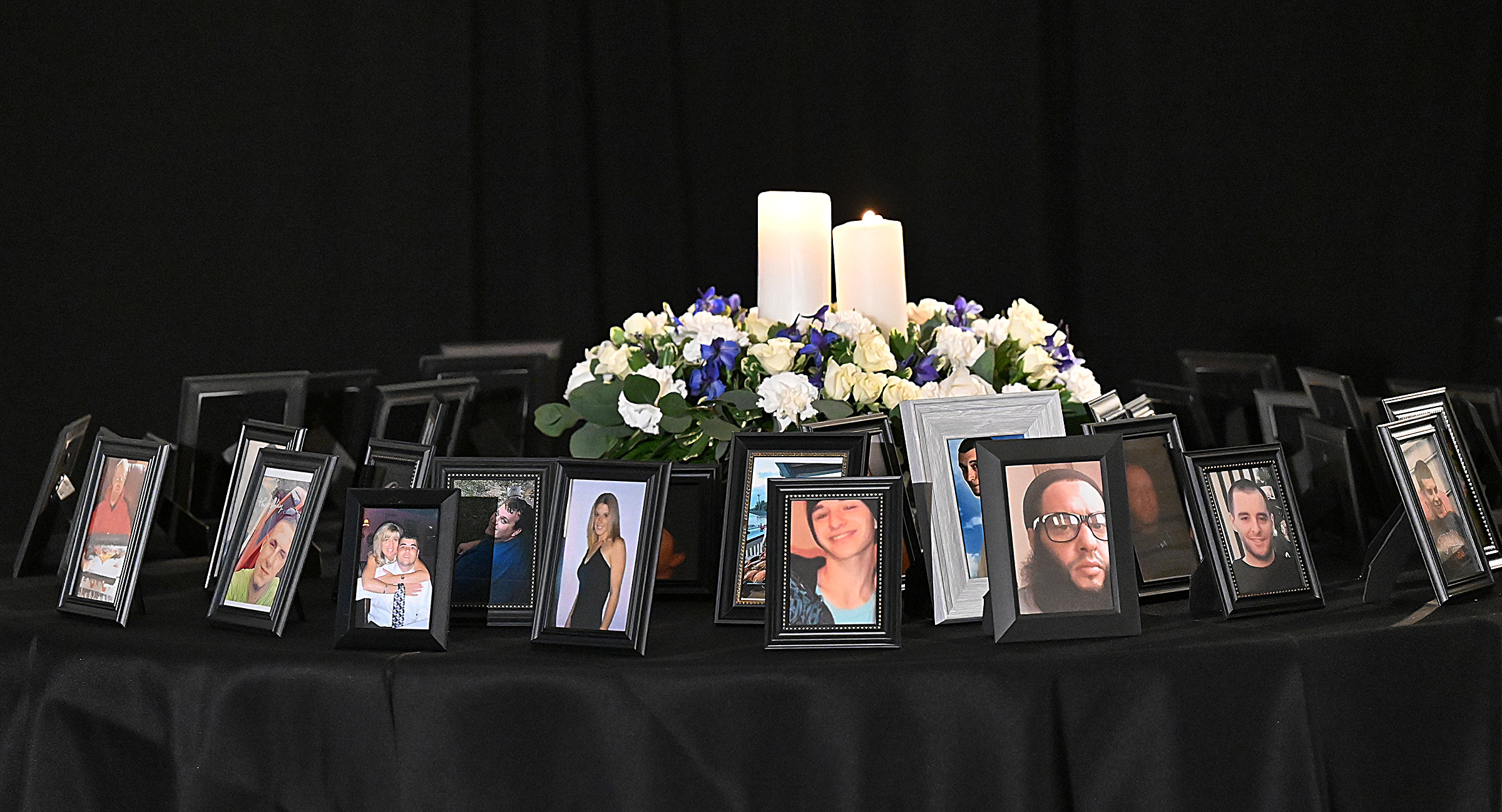 One of three tables displayed phgotos of friends and loved ones lost to drug overdose. The State's Attorney's office hosted Carroll County's 9th Annual Drug Overdose and Prevention Vigil Tuesday at Portico at St. John in Westminster. (Jeffrey F. Bill/Staff photo)