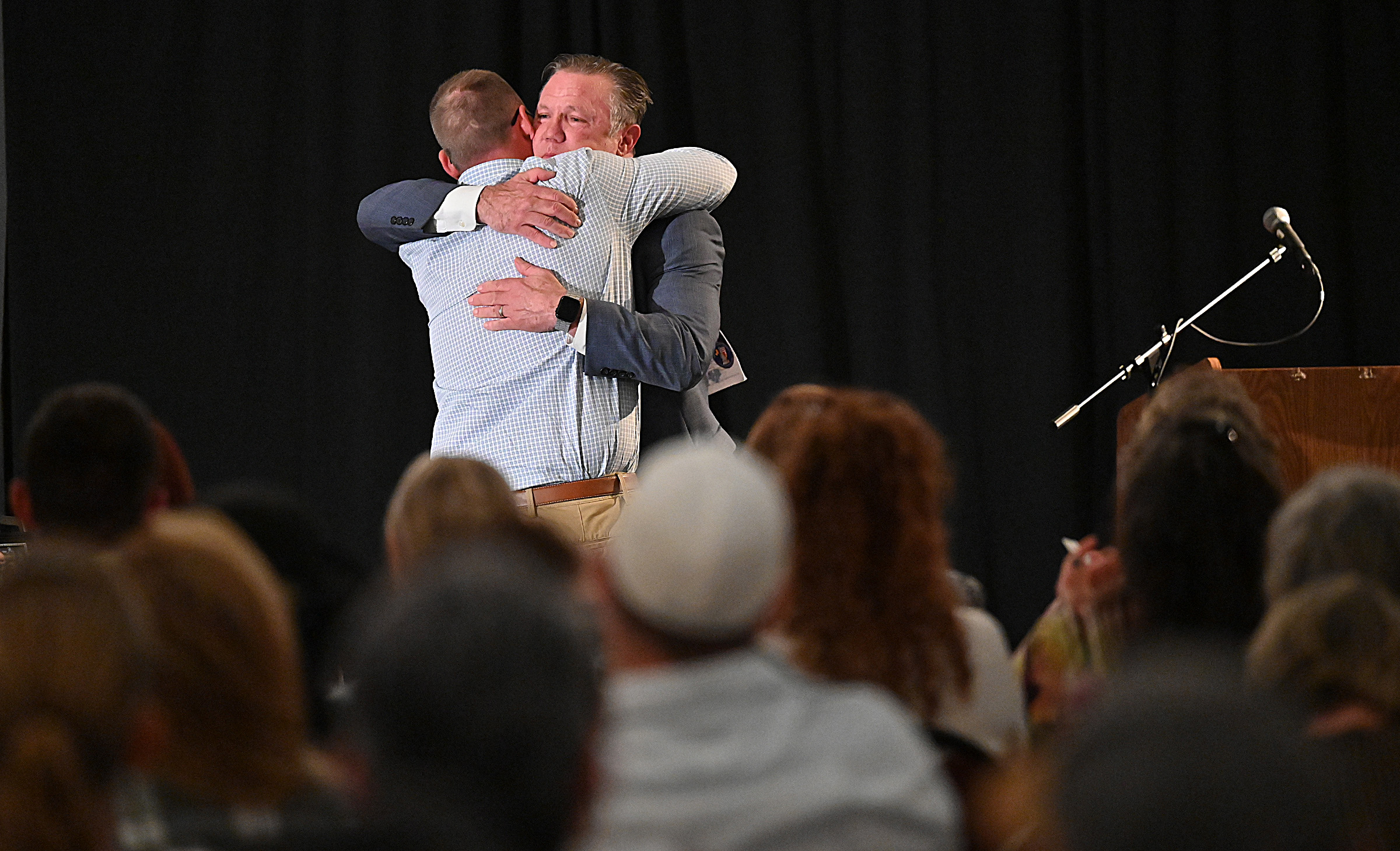 Tim Weber, Community Education Liaison for the States Attorney's Office, hugs Brian Kimmel, after introducing him to give "A Recovery Perspective" at the 9th Annual Drug Overdose and Prevention Vigil Tuesday at Portico at St. John in Westminster. (Jeffrey F. Bill/Staff photo)