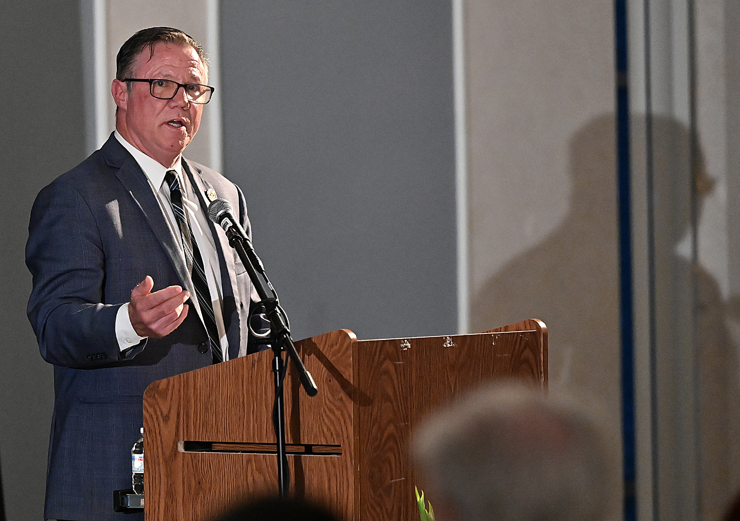 Tim Weber, offers those who lost friends and loved ones to drug overdose to come up and light a candle in their memory as he reads their names at the 9th Annual Drug Overdose and Prevention Vigil Tuesday at Portico at St. John in Westminster. (Jeffrey F. Bill/Staff photo)