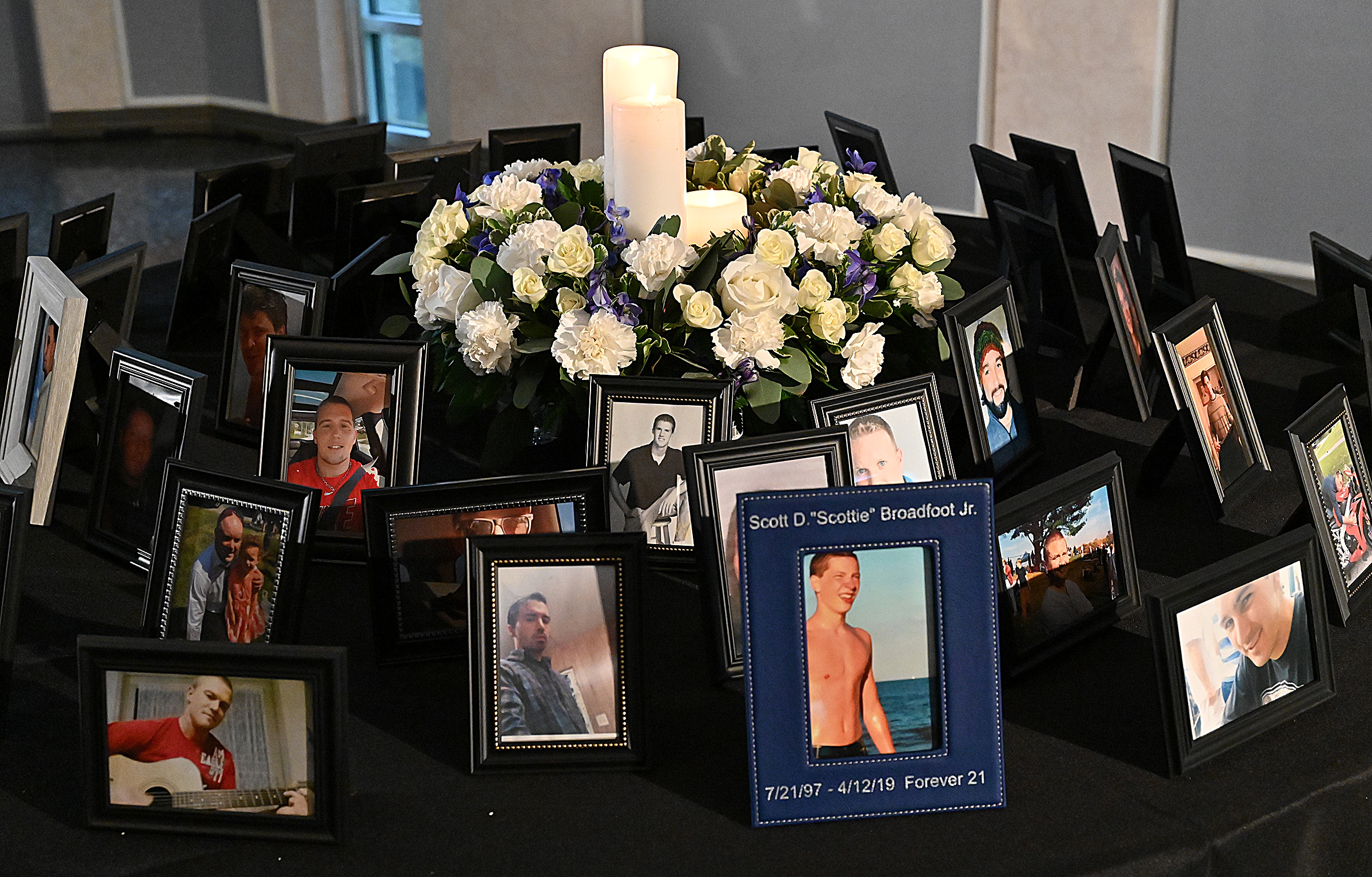 One of three tables displayed phgotos of friends and loved ones lost to drug overdose. The State's Attorney's office hosted Carroll County's 9th Annual Drug Overdose and Prevention Vigil Tuesday at Portico at St. John in Westminster. (Jeffrey F. Bill/Staff photo)