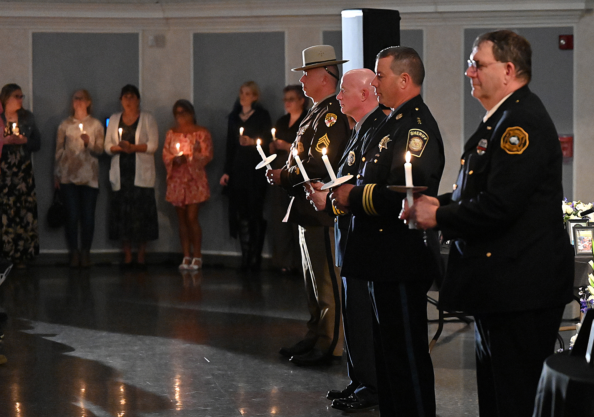 Left to right, Maryland State Police Detective Sergeant Jon M. McGee, Westminster Police Chief Thomas Ledwell, Carroll County Sheriff Jim DeWees and Westminster Common Councilmember Kevin E. Dayhoff, light candles for those remembering friends and loved ones lost to drug overdose at the 9th Annual Drug Overdose and Prevention Vigil Tuesday at Portico at St. John in Westminster. (Jeffrey F. Bill/Staff photo)