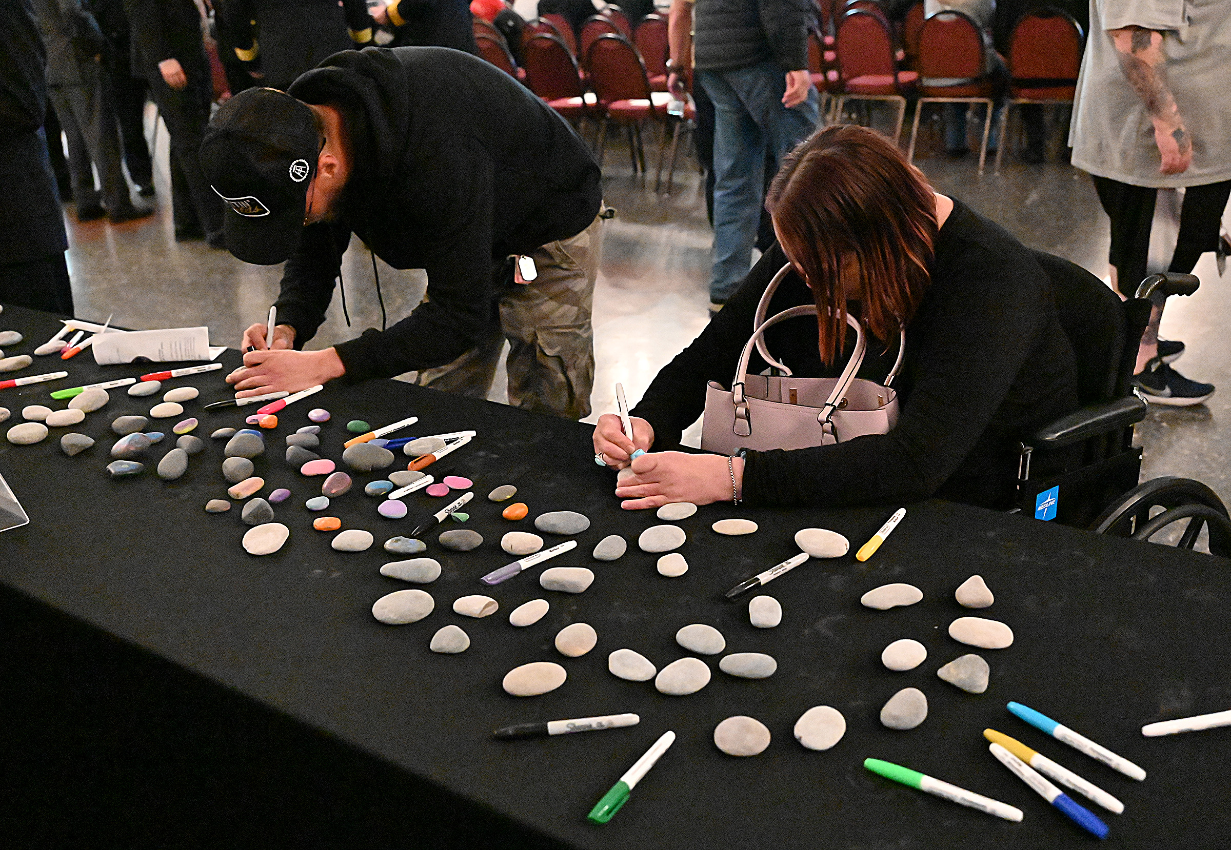 Brandon Stach, 3 years clean, and Jennifer Freeman from Maddie's House, create Memory Stones for those they have lost to drug overdose. The State's Attorney's office hosted Carroll County's 9th Annual Drug Overdose and Prevention Vigil Tuesday at Portico at St. John in Westminster. (Jeffrey F. Bill/Staff photo)