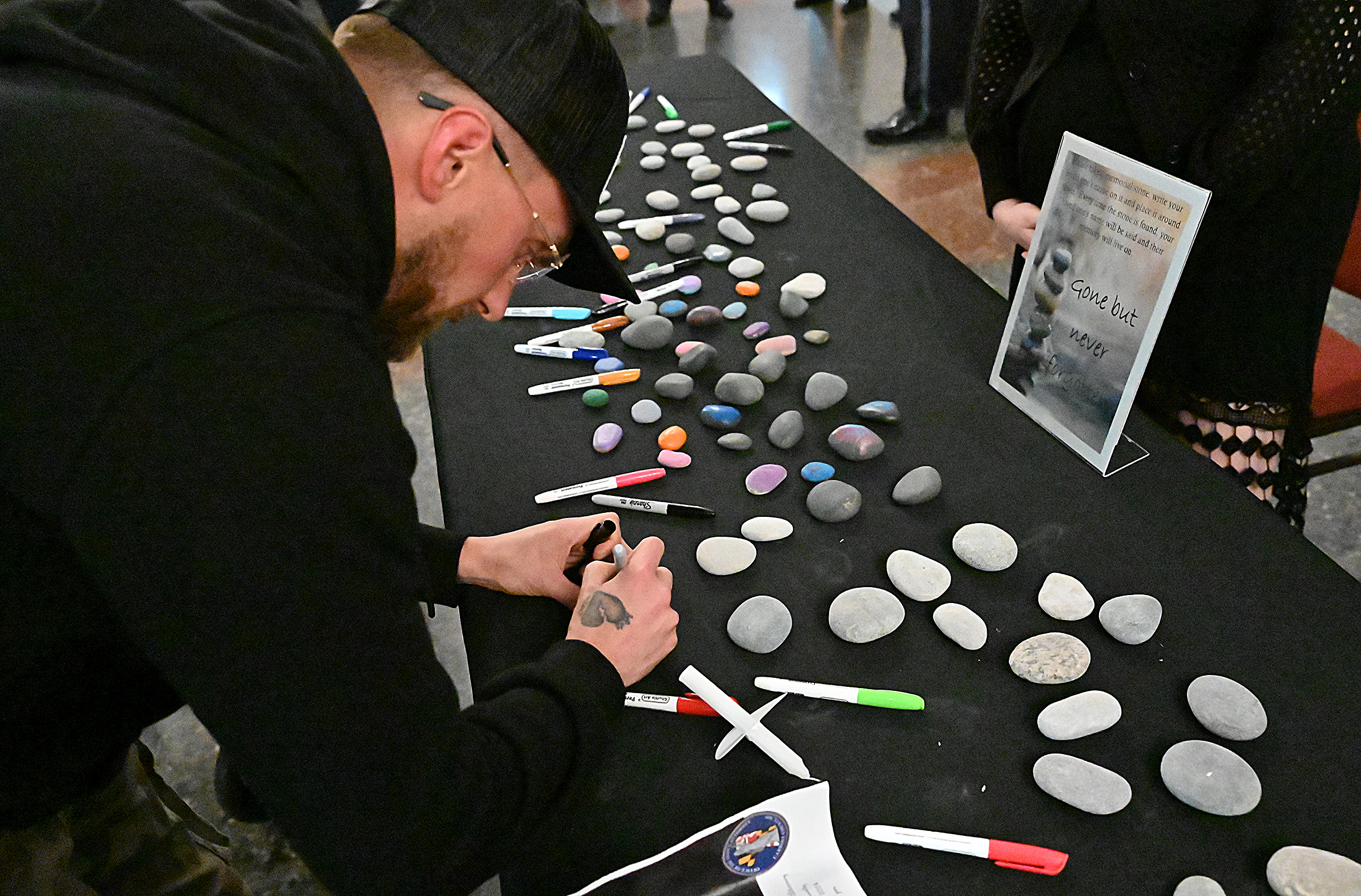 Brandon Stach, 3 years clean, creates a Memory Stone for his many friends lost to drug overdose. The State's Attorney's office hosted Carroll County's 9th Annual Drug Overdose and Prevention Vigil Tuesday at Portico at St. John in Westminster. (Jeffrey F. Bill/Staff photo)