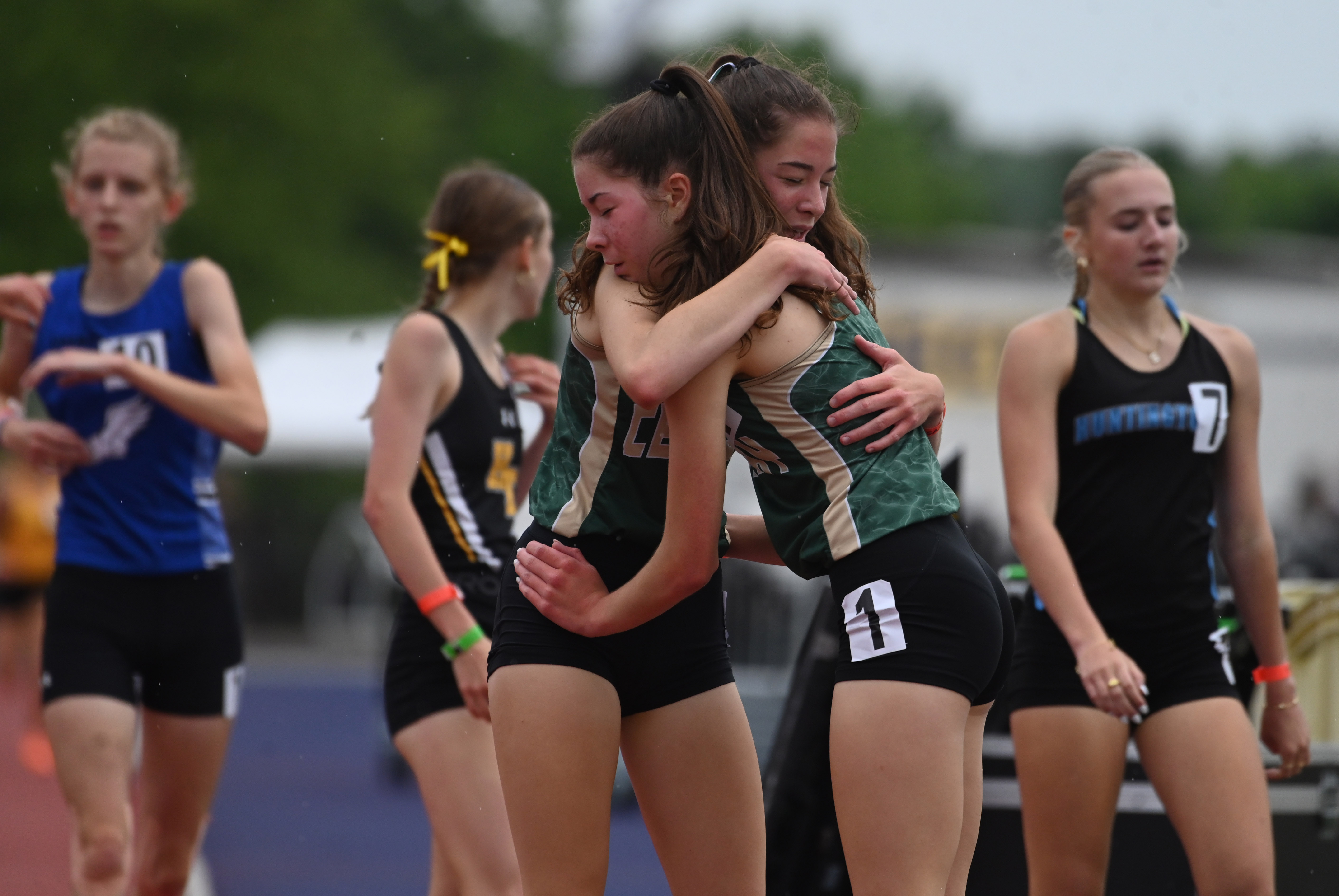 Century's Emily Mitroka embraced by her sister, and fellow runner, Elizabeth Mitroka after winning the 2A girls 1,600-meter run during the MPSSAA Track and Field State Championships at Prince George's Sports and Learning Complex on Thursday. (Brian Krista/staff photo)