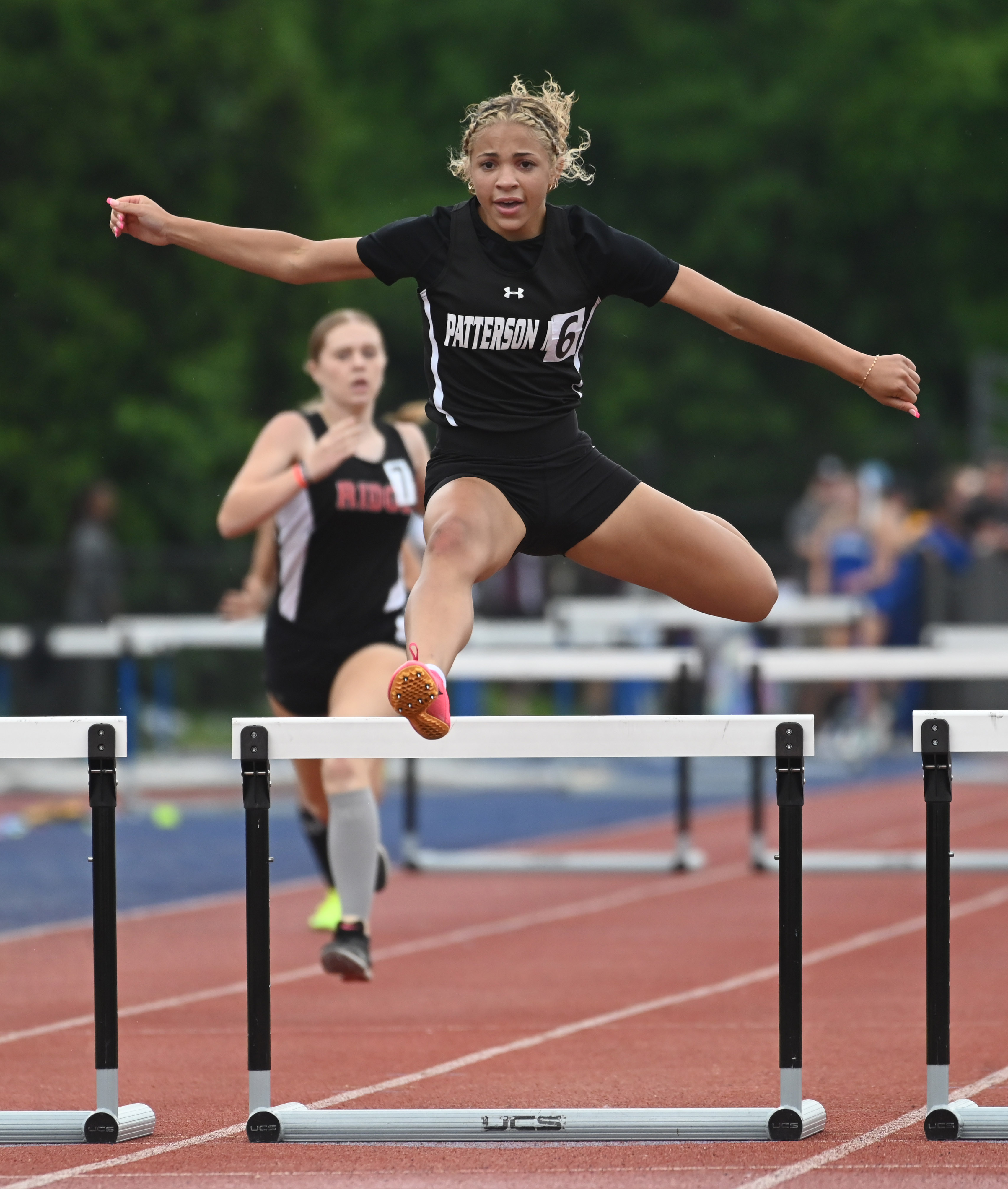 Patterson Mill's Jalynn Mayfield-Rice clears the final hurdle as she competes in the 1A girls 300 meter hurdles during the MPSSAA Track and Field State Championships at Prince George's Sports and Learning Complex on Thursday. (Brian Krista/staff photo)