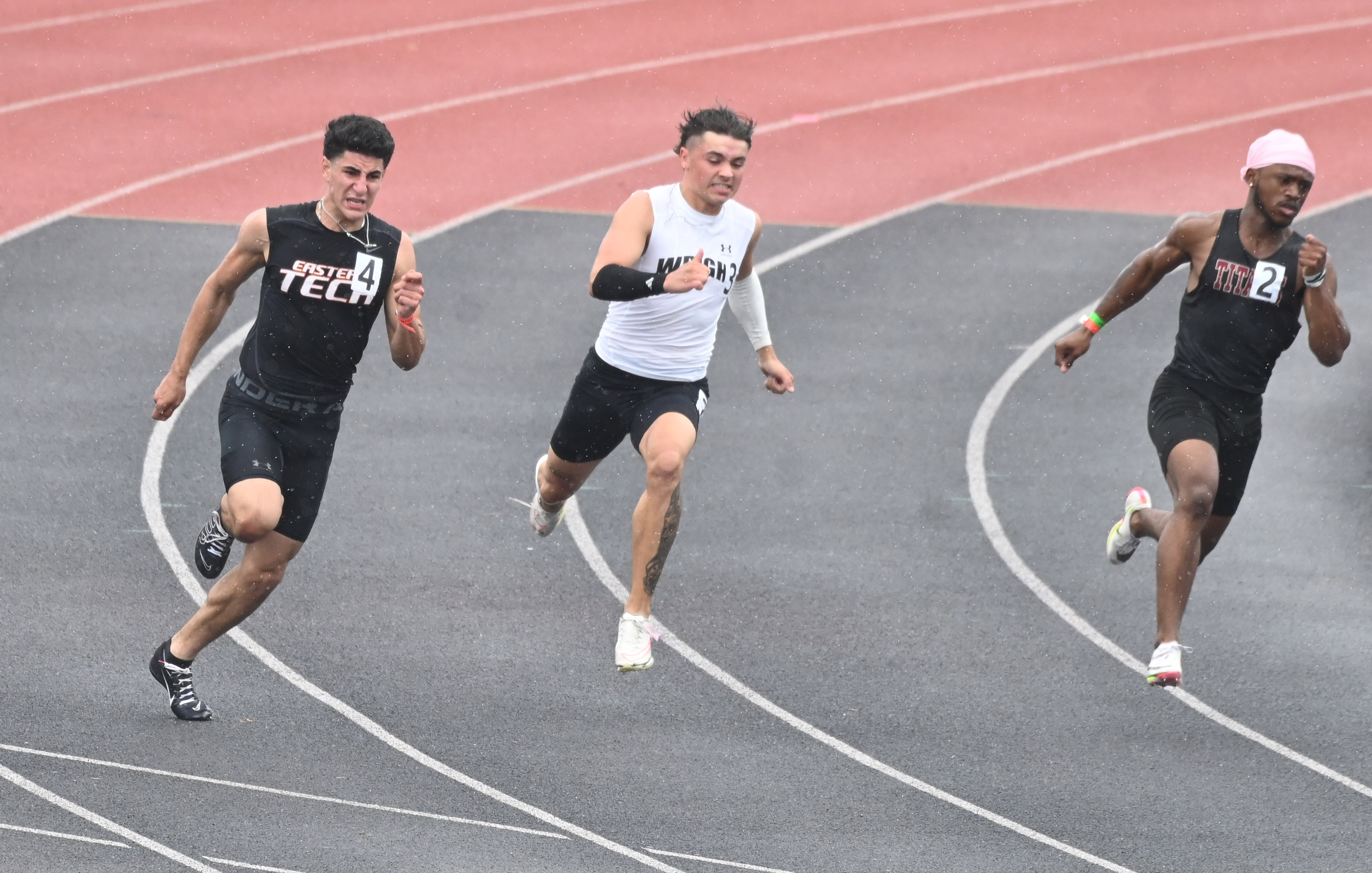 Runners in the 2A boys 200 meter dash, from left, Eastern Tech's Ameer Mowad, C. Milton Wright's Landon Krepps and New Town's Denver Shields compete in the final during the MPSSAA Track and Field State Championships at Prince George's Sports and Learning Complex on Thursday. (Brian Krista/staff photo)