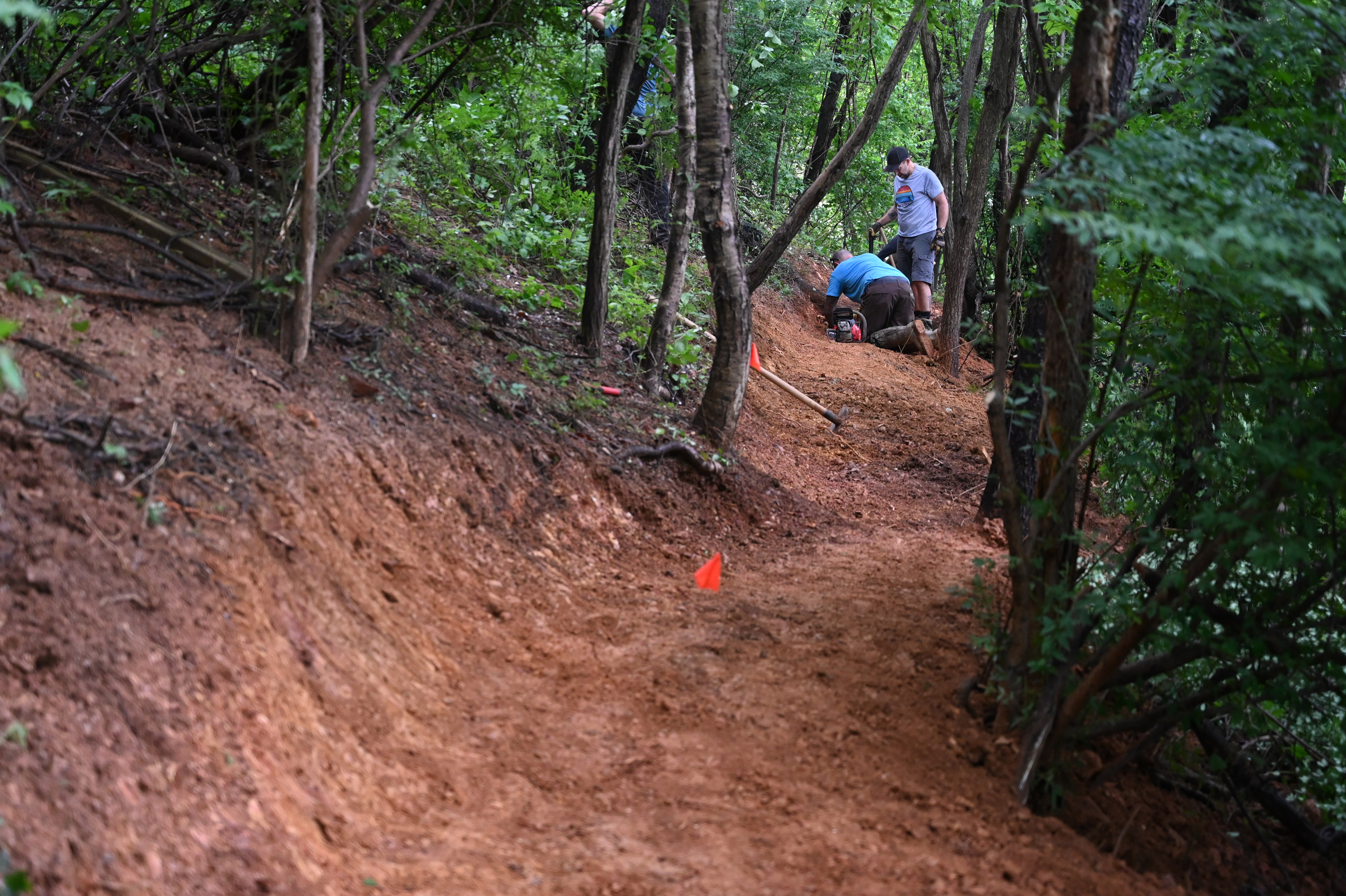 A portion of a new bike path is seen as a group of volunteers make progress in the creation of Windy Ridge Trails at Mount Airy's East West Park on Saturday. (Brian Krista/staff photo)