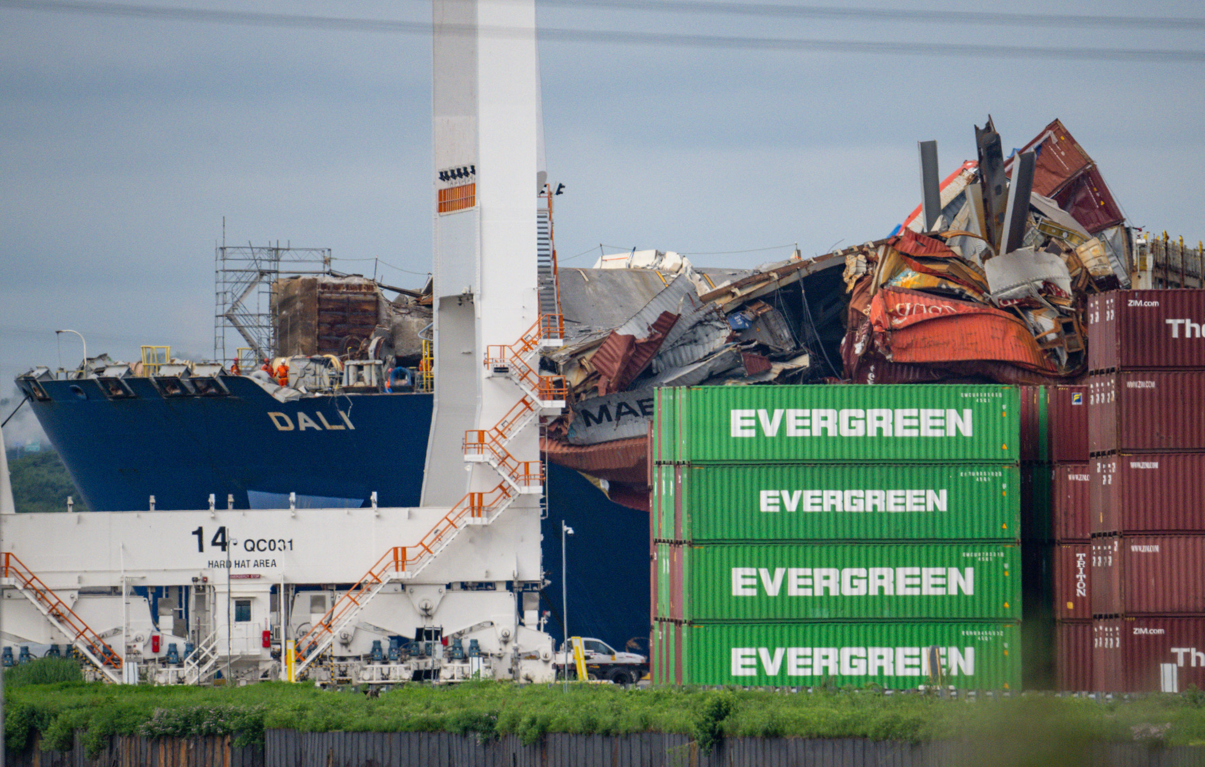 Crushed shipping containers are seen on the container ship Dali as it is moved into the Seagirt Marine Terminal fifty-five days after it hit a structural pier of the Francis Scott Key Bridge causing a catastrophic collapse.(Jerry Jackson/Staff)