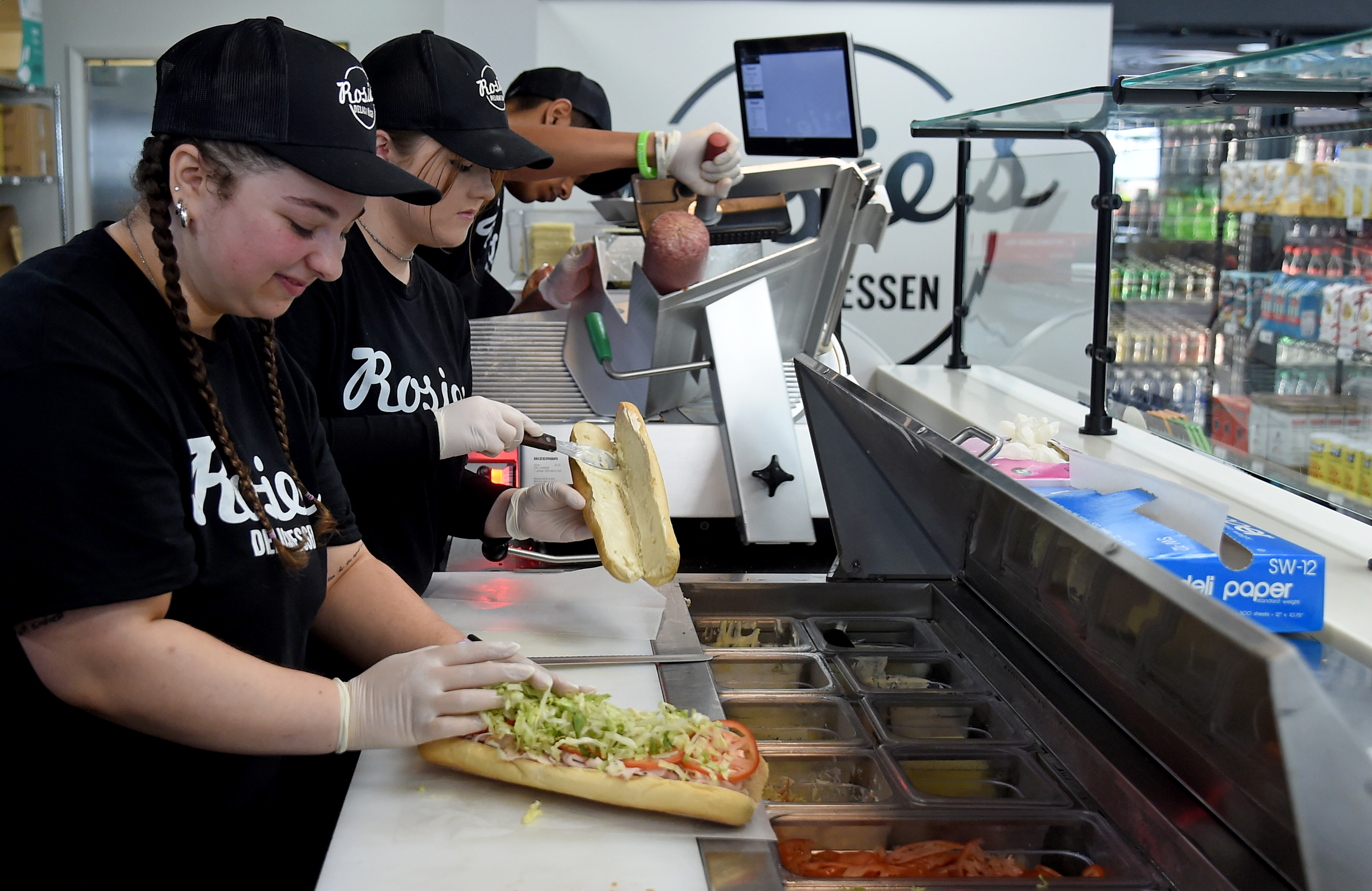 Maddie Repole, left, makes a turkey sub with "the works" at Rosie's Delicatessen, which has been named best in Howard County. (Barbara Haddock Taylor/Staff)