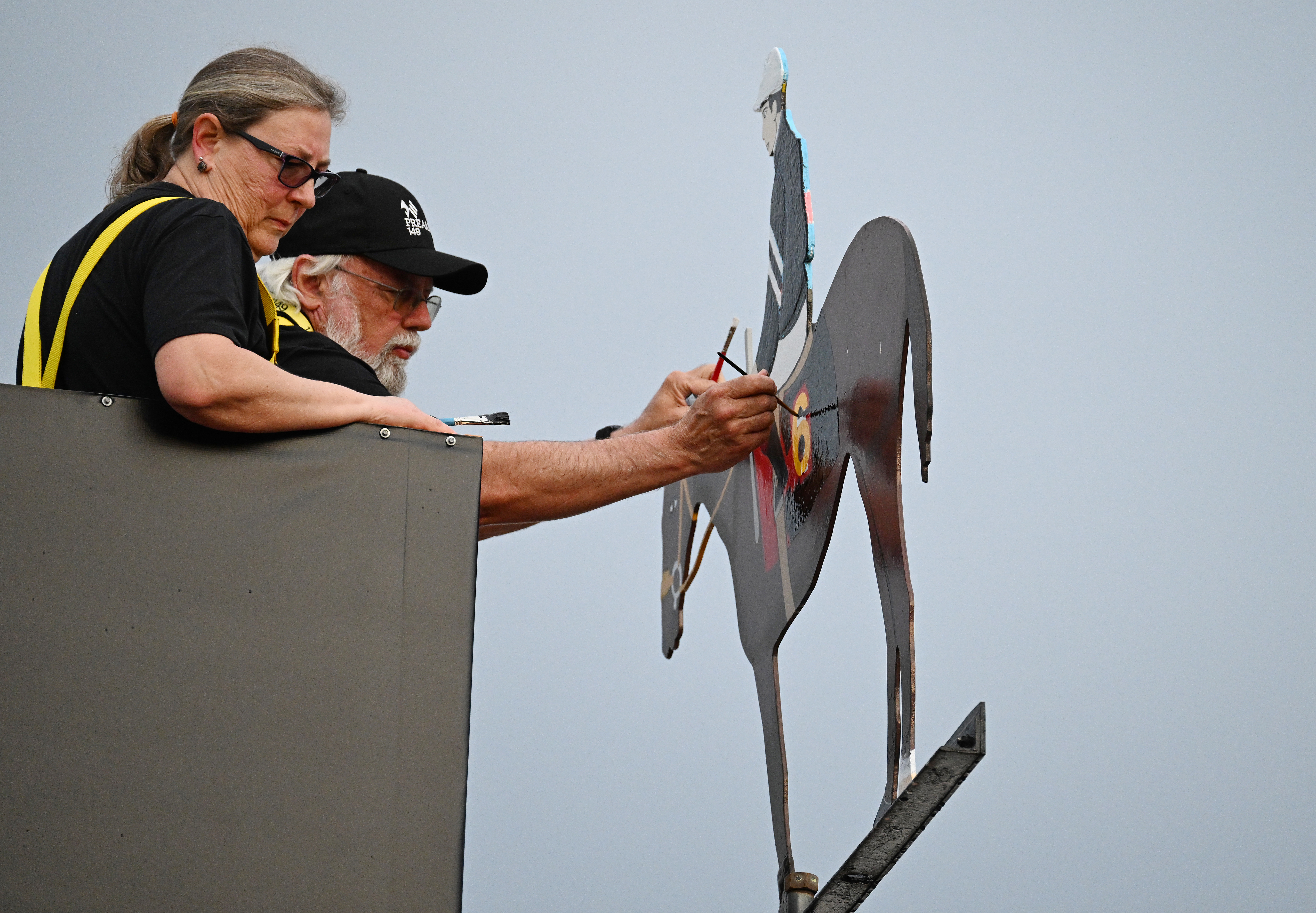 Painters paint the weather vane of the cupola in the winners circle after Jaime Torres rode Seize the Grey to victory in the 149th running of the Preakness Stakes. (Kim Hairston/Staff)