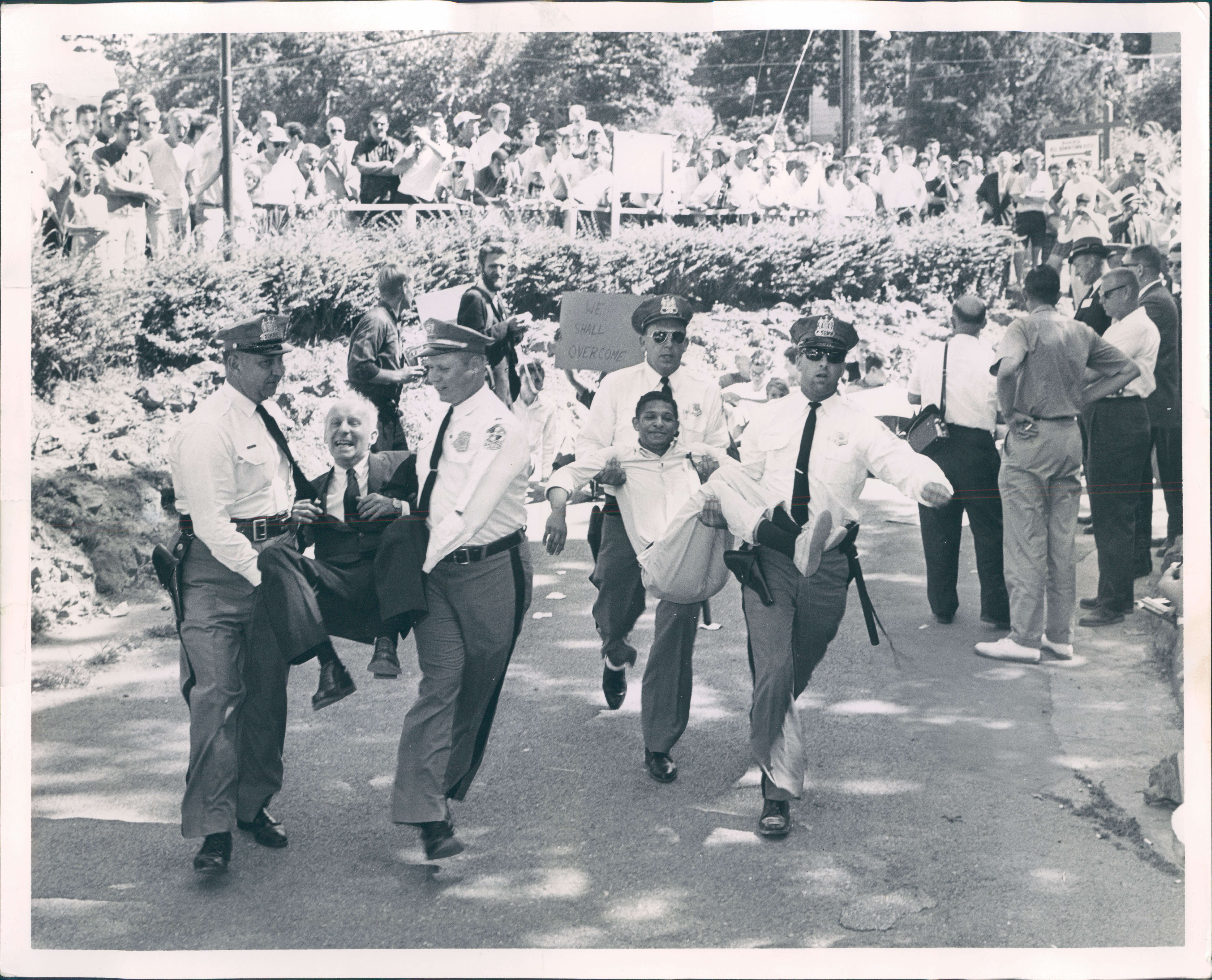July 5, 1963 - ALLEY OOP -- Baltimore county policemen carry a demonstrator from Gwynn Oak park. Protestors numbered in the hundreds. Photo by Walter M. McCardell AGU-123-BSDate Created: 1963-07-04 Copyright Notice: Baltimore Sun Folder Description: Segregation Folder Extended Description: Baltimore and Maryland Title: SEGREGATION BALTIMORE AND MARYLAND