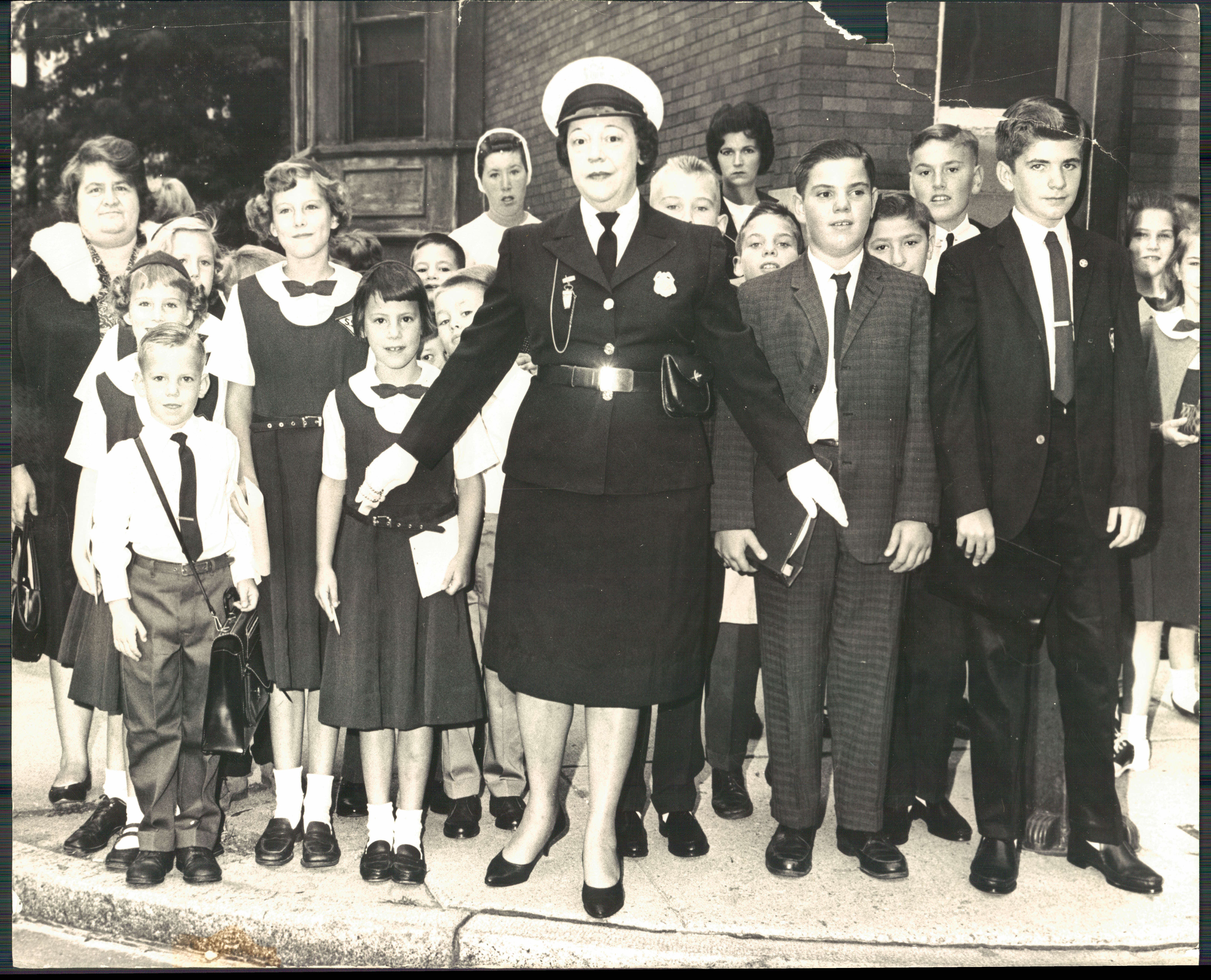September 5, 1963-THE EAGER BEAVERS Mrs. Naomi Fitzhugh, a school crossing guard, holds back students at Twenty-Seventh street and Maryland avenue who were en route to S. S. Philip and James School. Photo by Sun photographer Walter McCardell. BAQ-547-BSDate Created: 1963-09-05 Copyright Notice: Baltimore Sun Folder Description: Schools, Baltimore Re-opening Folder Extended Description: SCHOOLS, BALTIMORE REOPENING Title: SCHOOLS, BALTIMORE REOPENING Subject: SCHOOLS, BALTIMORE