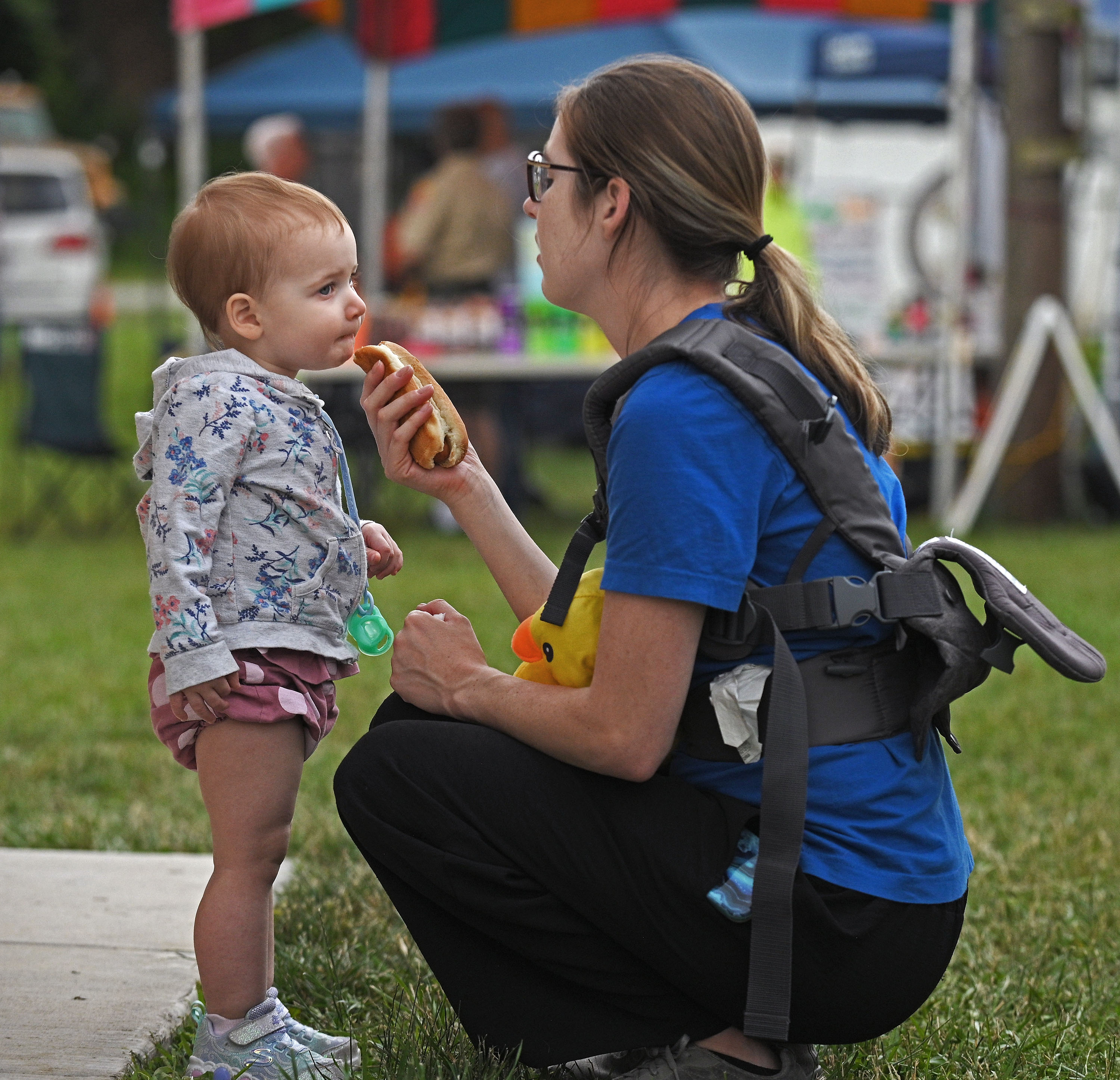 Kaili Johnson, right, of Sykesville, holds a hot dog being eaten by 1-year-old daughter M.J. at Sykesville Freedom District Fire Department's Annual firemen's carnival which runs from June 8-15. (Kenneth K. Lam/Staff)