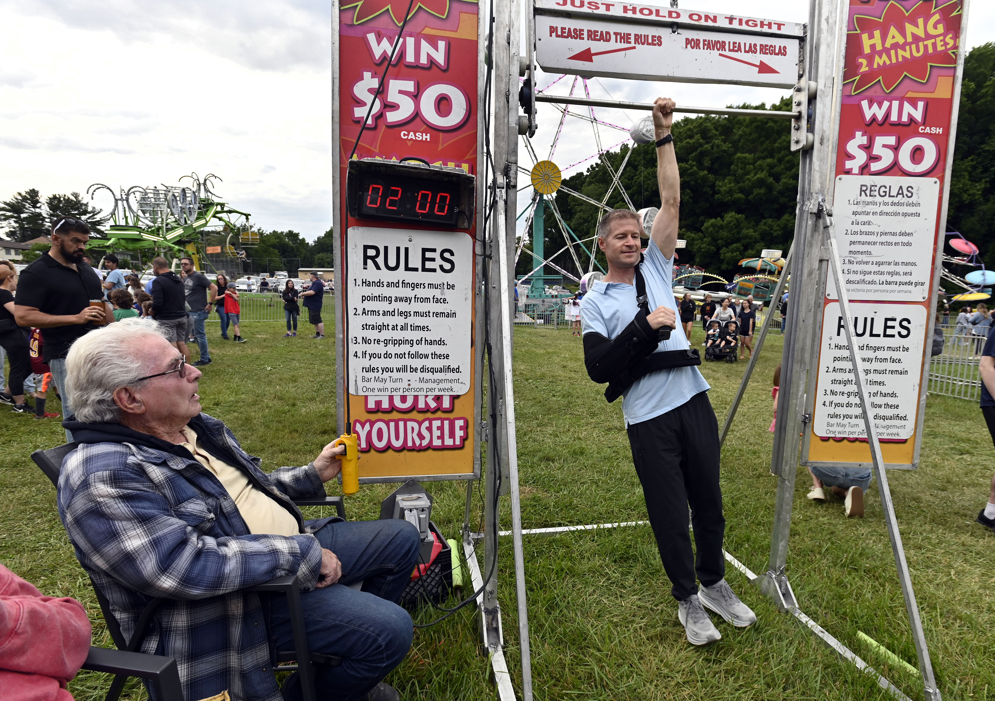 Carnival games operator Ralph Shaw, left, lets Jeremy Davis, of Eldersburg, experience the Hang Time game during Sykesville Freedom District Fire Department's Annual firemen's carnival which runs from June 8-15. (Kenneth K. Lam/Staff)