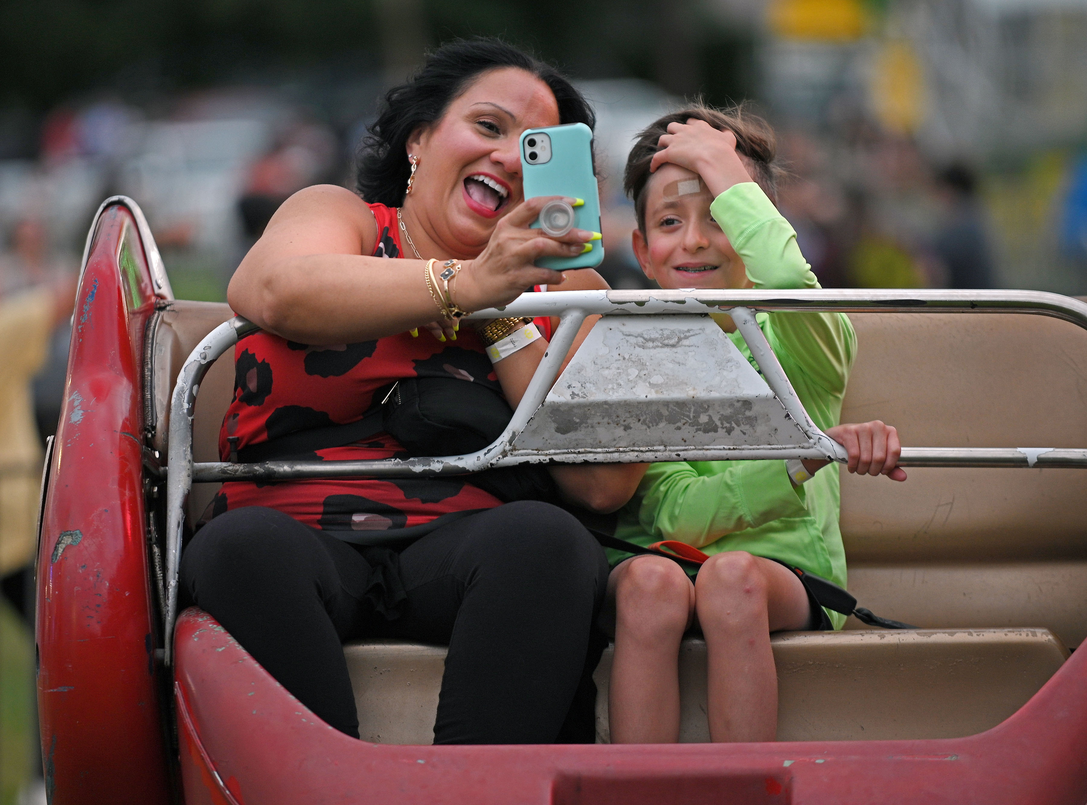 Nilita Salgado, left, of Orlando, Fl., takes selfie with nephew Brayden Grafton, 10, after ridding the Sizzler at Sykesville Freedom District Fire Department's Annual firemen's carnival. Salgado, who is visiting family in Sykesville, said the small carnival rides remind her of her childhood. The carnival runs from June 8-15. (Kenneth K. Lam/Staff)