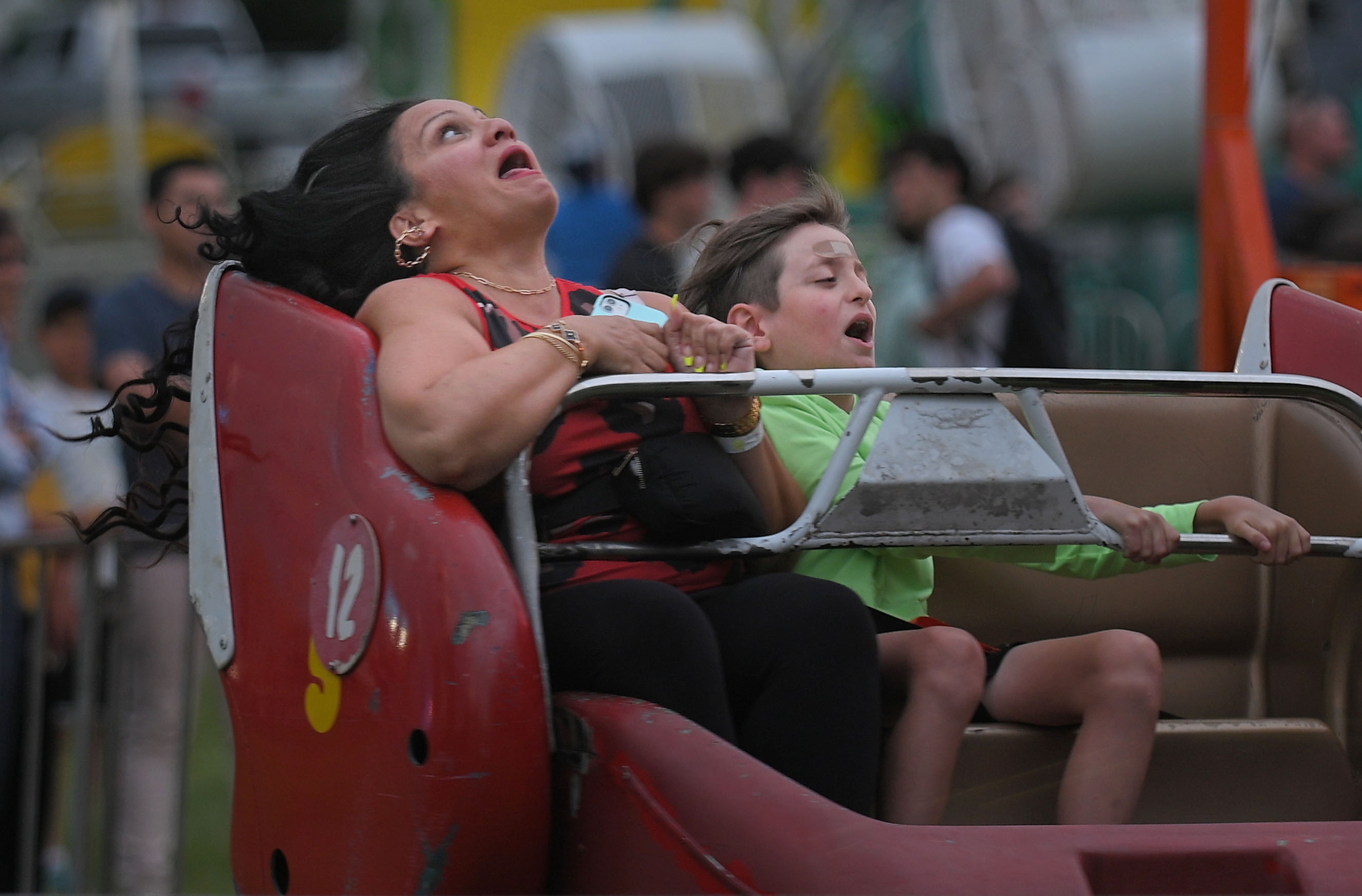 Nilita Salgado, left, of Orlando, Fl., reacts while ridding the Sizzler with nephew Brayden Grafton, 10, at Sykesville Freedom District Fire Department's Annual firemen's carnival. Salgado, who is visiting family in Sykesville, said the small carnival rides remind her of her childhood. The carnival runs from June 8-15. (Kenneth K. Lam/Staff)