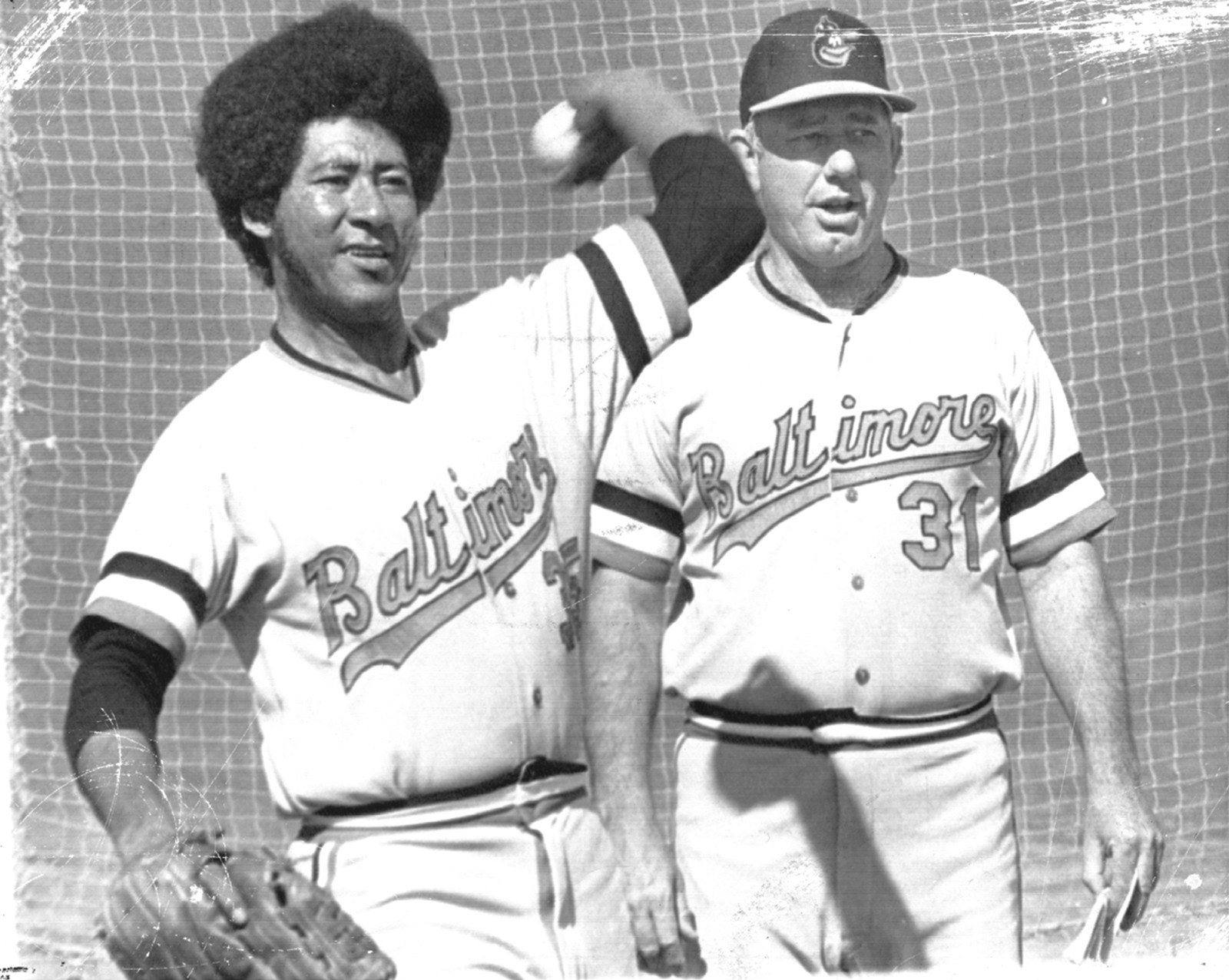 Mike Cuellar loosens up at the Orioles' Miami Spring Training camp as George Bamberger, the pitching coach, looks on.