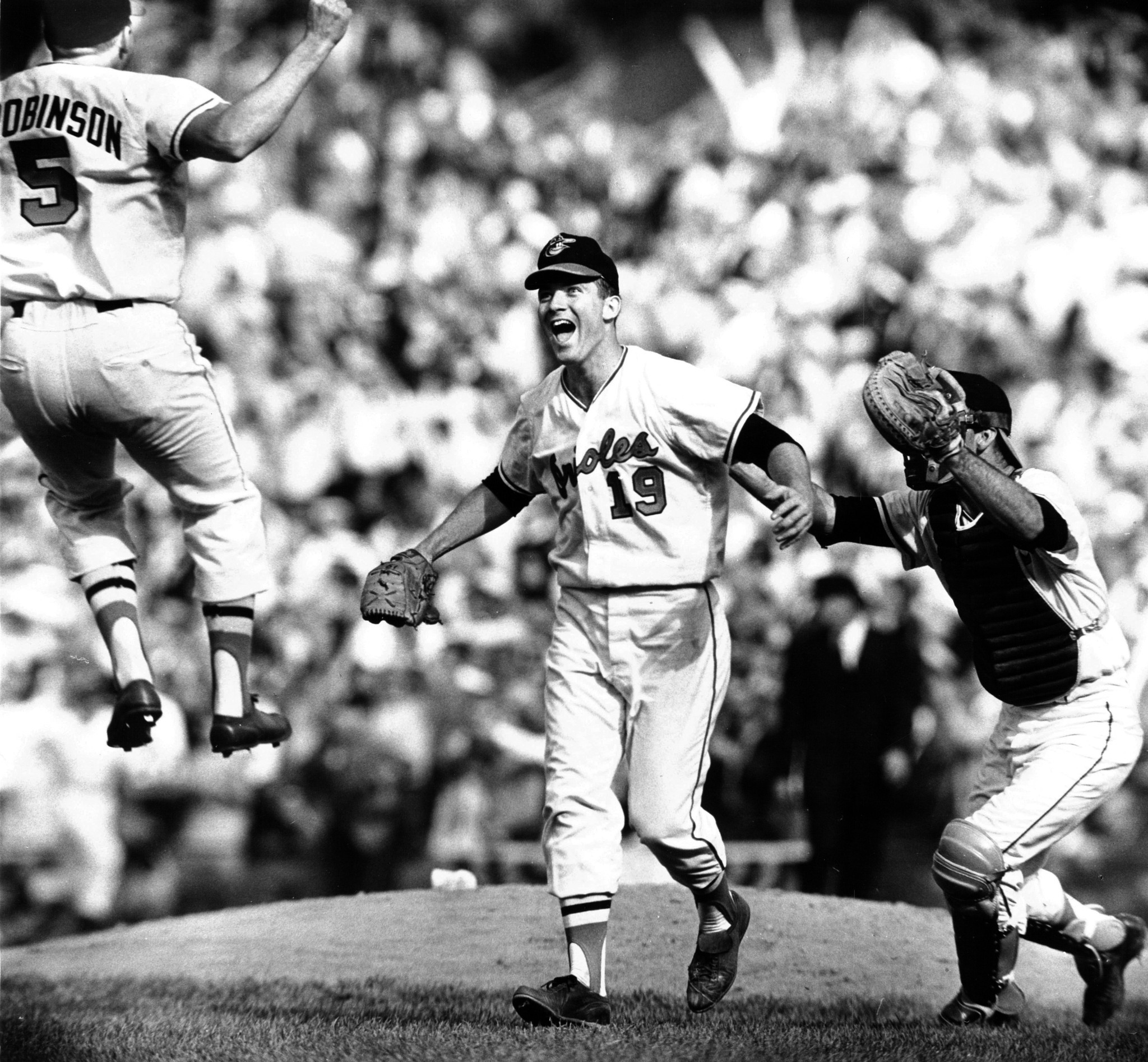 On Oct. 9, 1966 third baseman Brooks Robinson and catcher Andy Etchebarren converge on pitcher Dave McNally after the Orioles swept the Los Angeles Dodgers to win their first World Series.