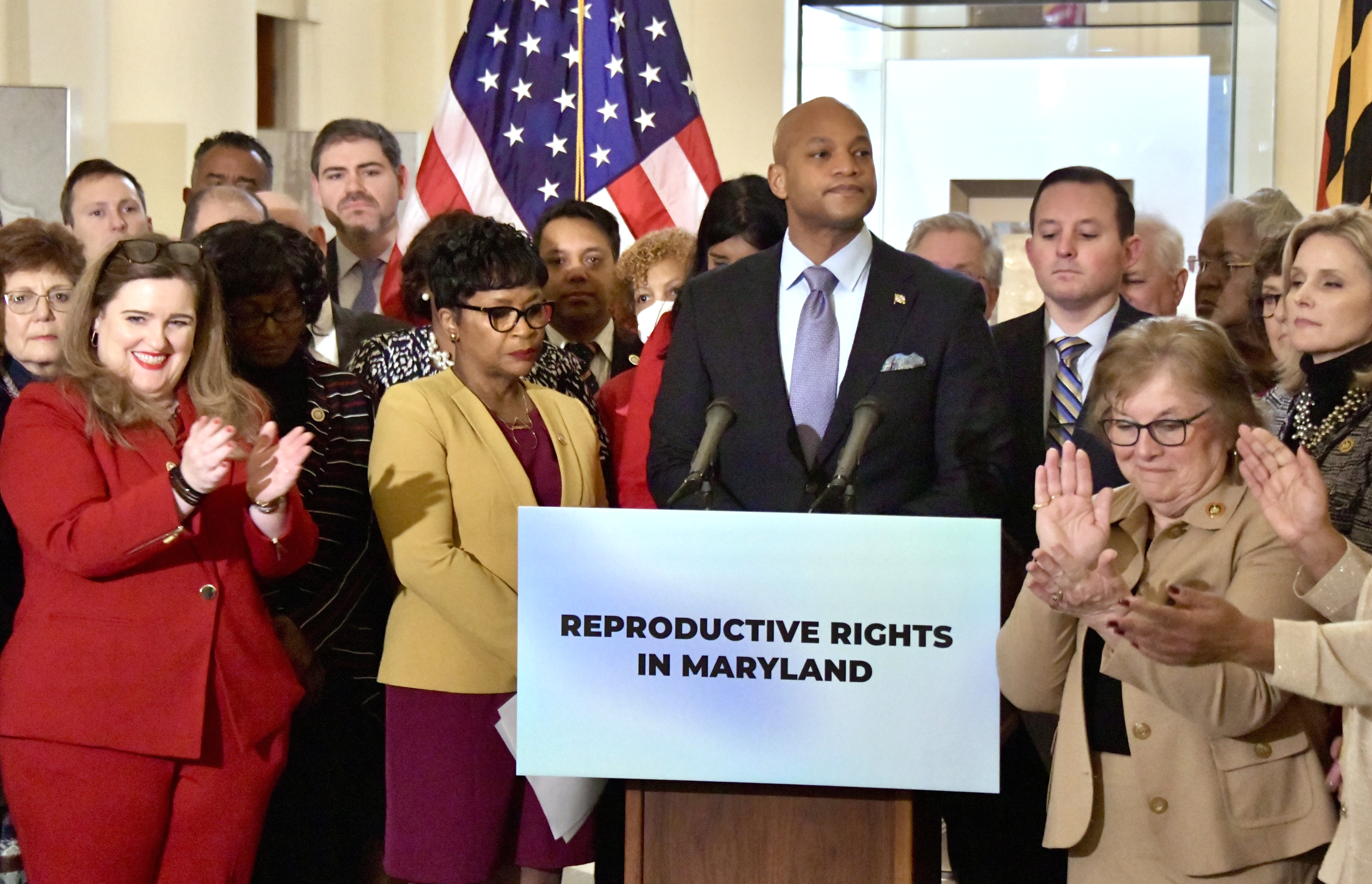 Gov. Wes Moore, flanked by Speaker of the House Adrienne A. Jones and Senate President Bill Ferguson, talked about his support of a package of abortion protection bills. Legislators applaud at the earlier State House news conference.