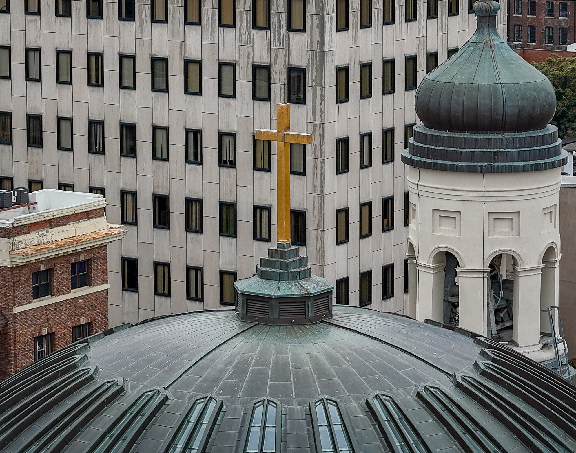 A gold cross is seen on the dome of the Baltimore Basilica on Cathedral Street across from the Baltimore Archdiocese headquarters. The Basilica, officially the Basilica of the National Shrine of the Assumption of the Blessed Virgin Mary, was the first Roman Catholic cathedral built in the United States. File. (Jerry Jackson/Baltimore Sun)