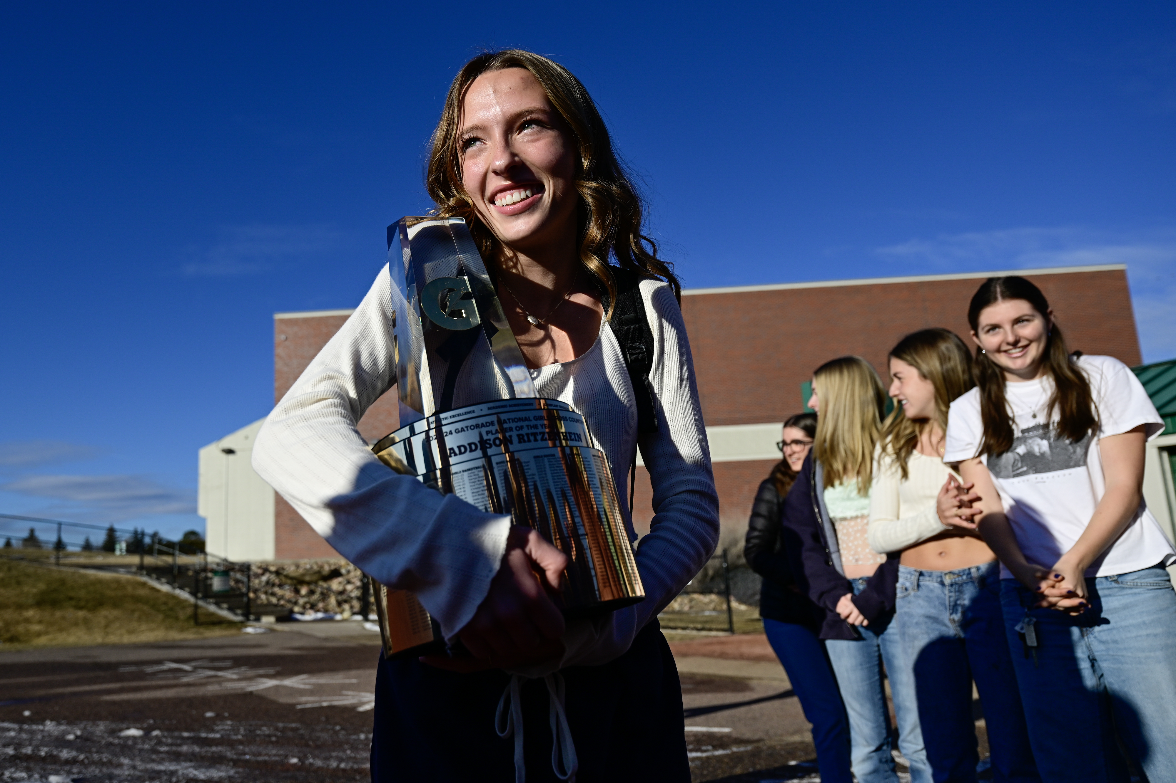 Niwot's Addison Ritzenhein reacts while surrounded by her teammates, coaches and family after winning the Gatorade Girls Cross Country Player of the Year award on Tuesday. (Matthew Jonas/Staff Photographer)