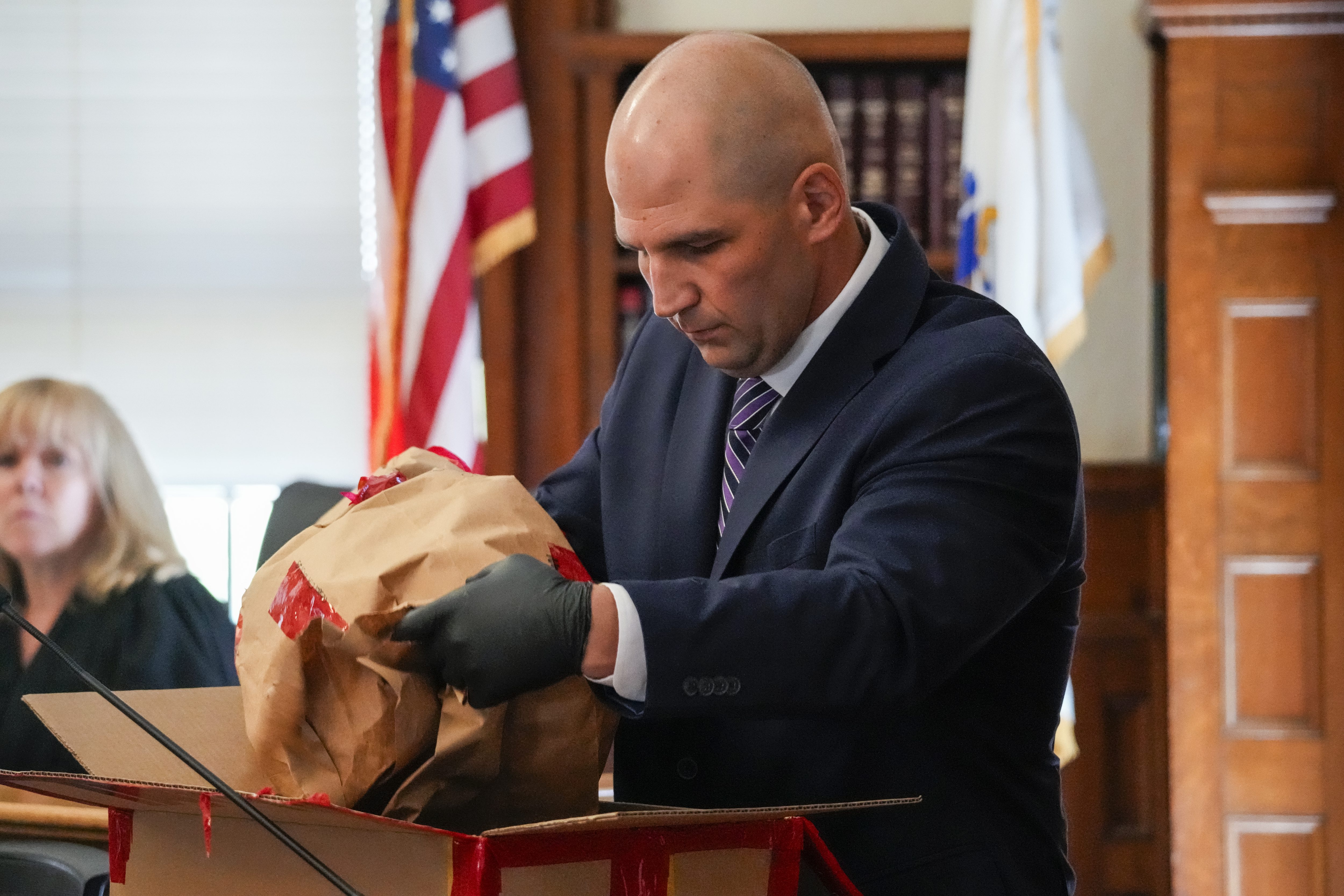 Massachusetts State Police Trooper Michael Proctor opens the evidence box during the Karen Read murder trial at Norfolk Superior Court. (Kayla Bartkowski/Pool)